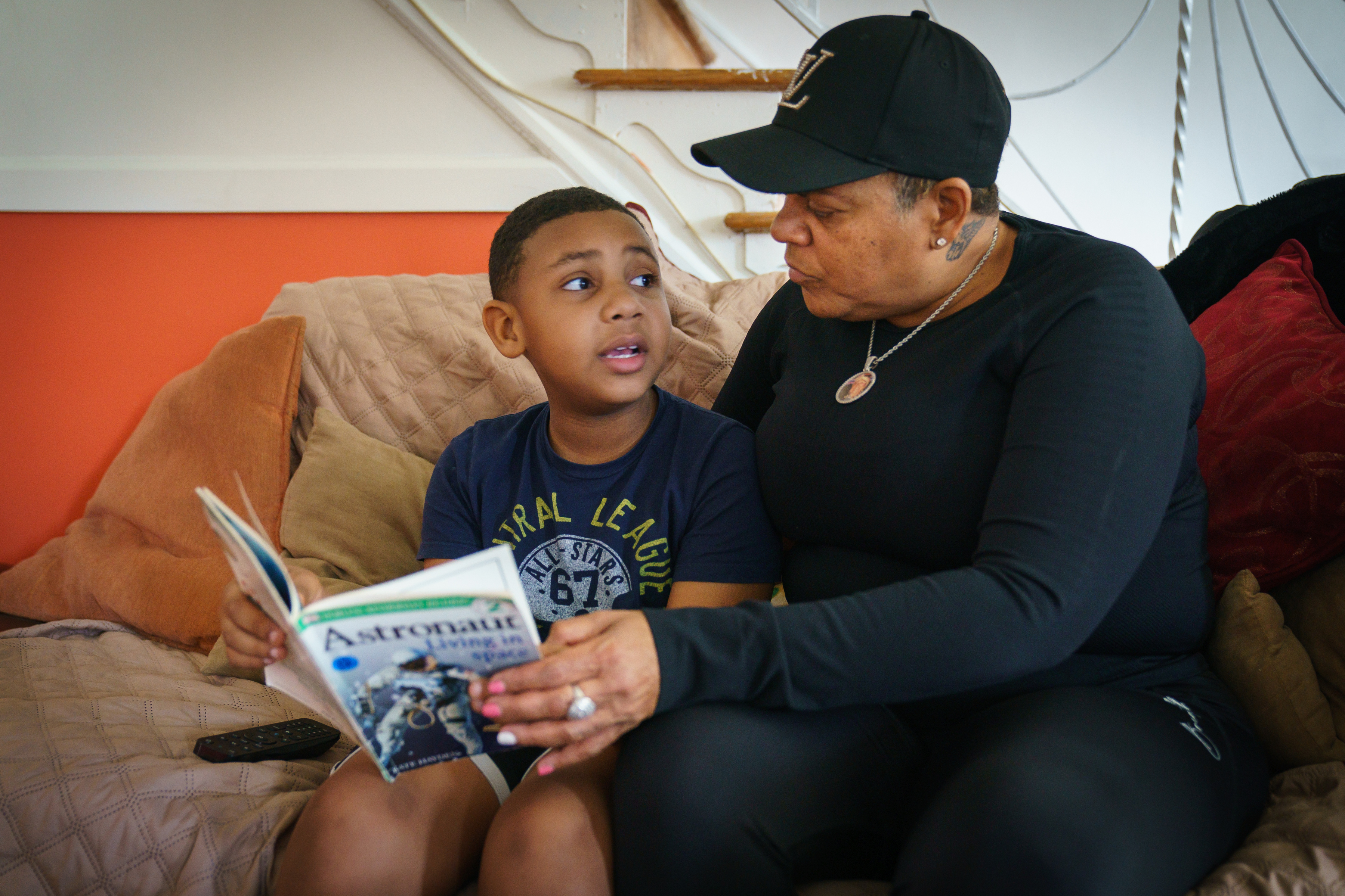 Karon Blackman Jr., 8, practices reading with his grandmother Sunday Rice at her Philadelphia home in April 2021, while Karon was on spring break from school.