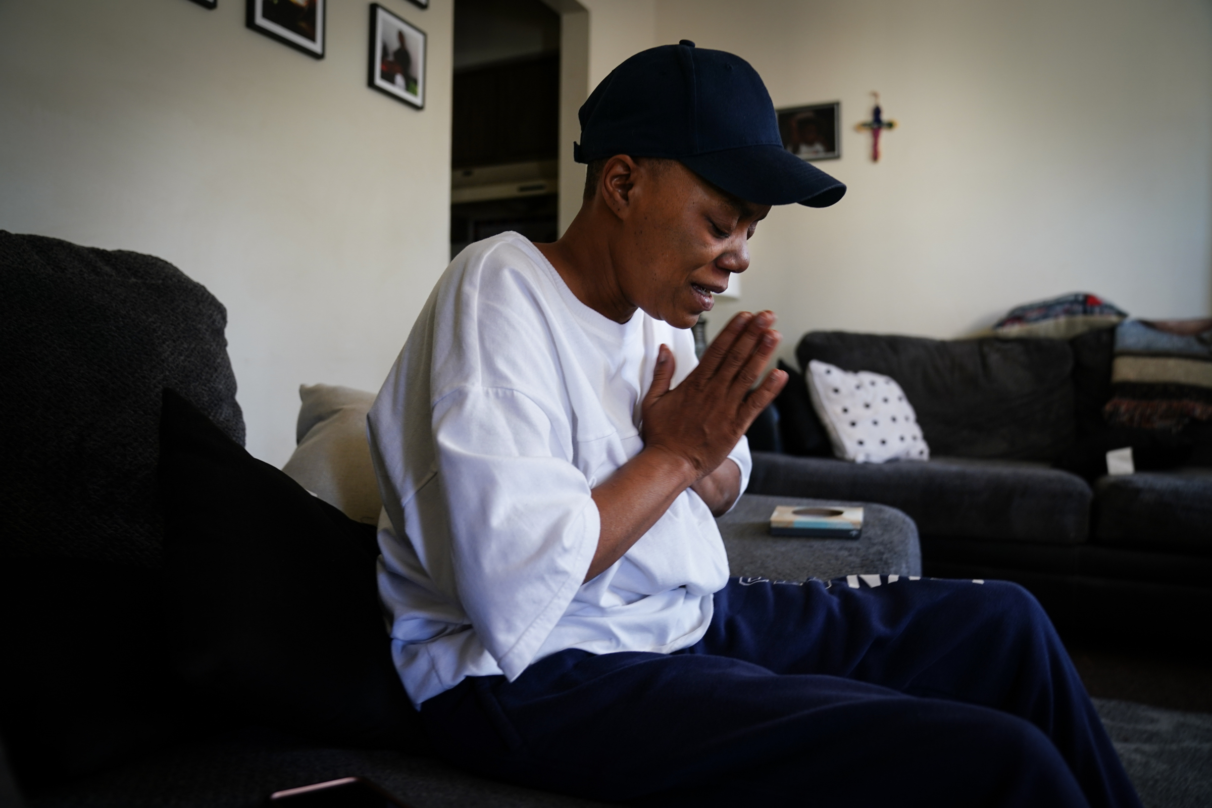 Josette Phillips prays for her son Donyea Phillips at her home in Spring City, Pa. She says he told her when he was arrested about abuse by detectives, but she saw no recourse.