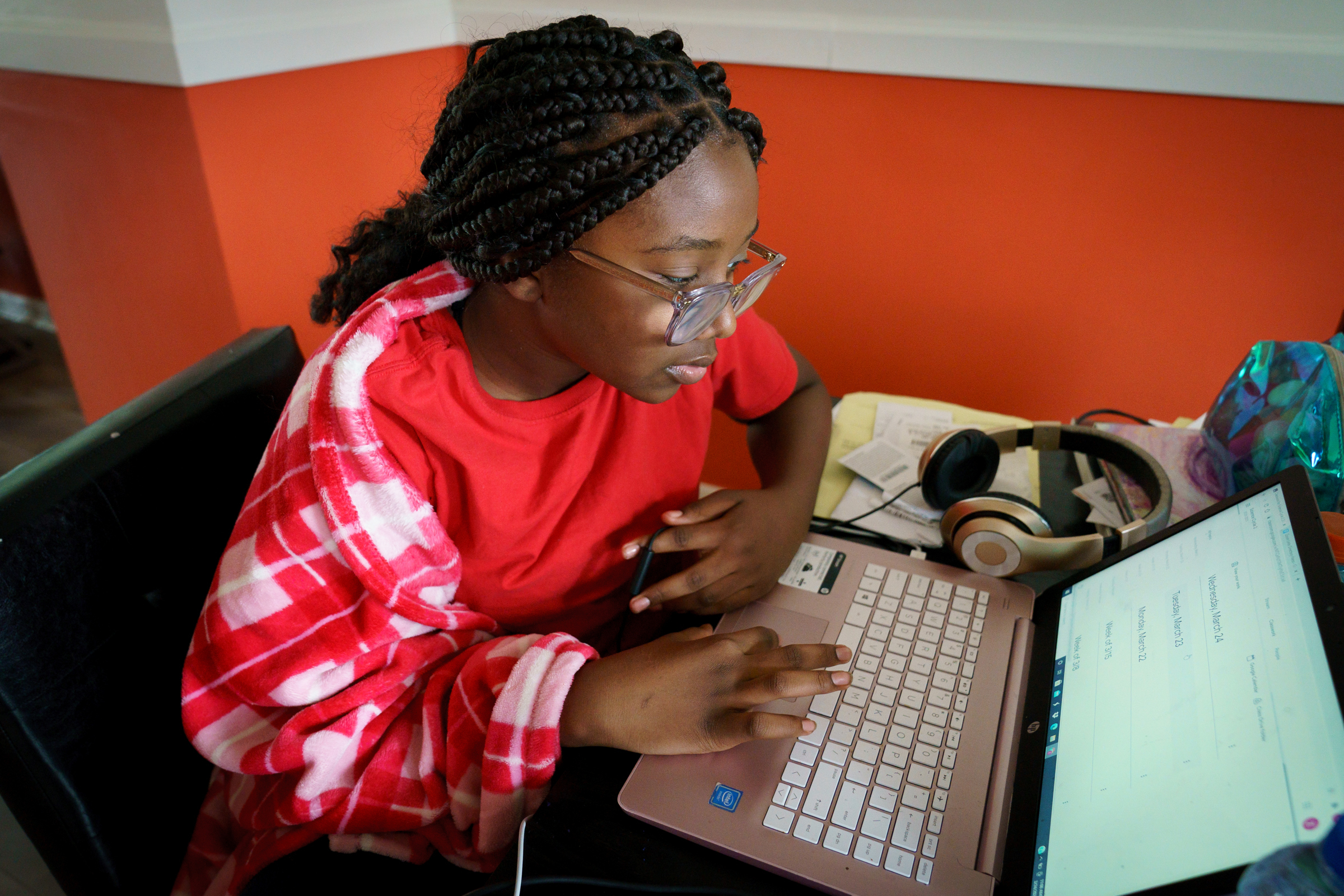 Zion Johnson, 11, participates in school online at her grandmothers house in Philadelphia.