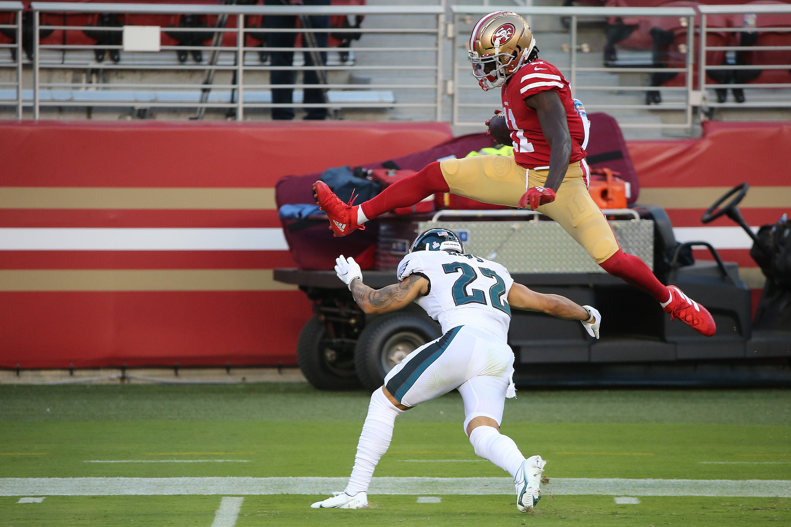 49ers wide receiver Brandon Aiyuk hurdles for touchdown, shows