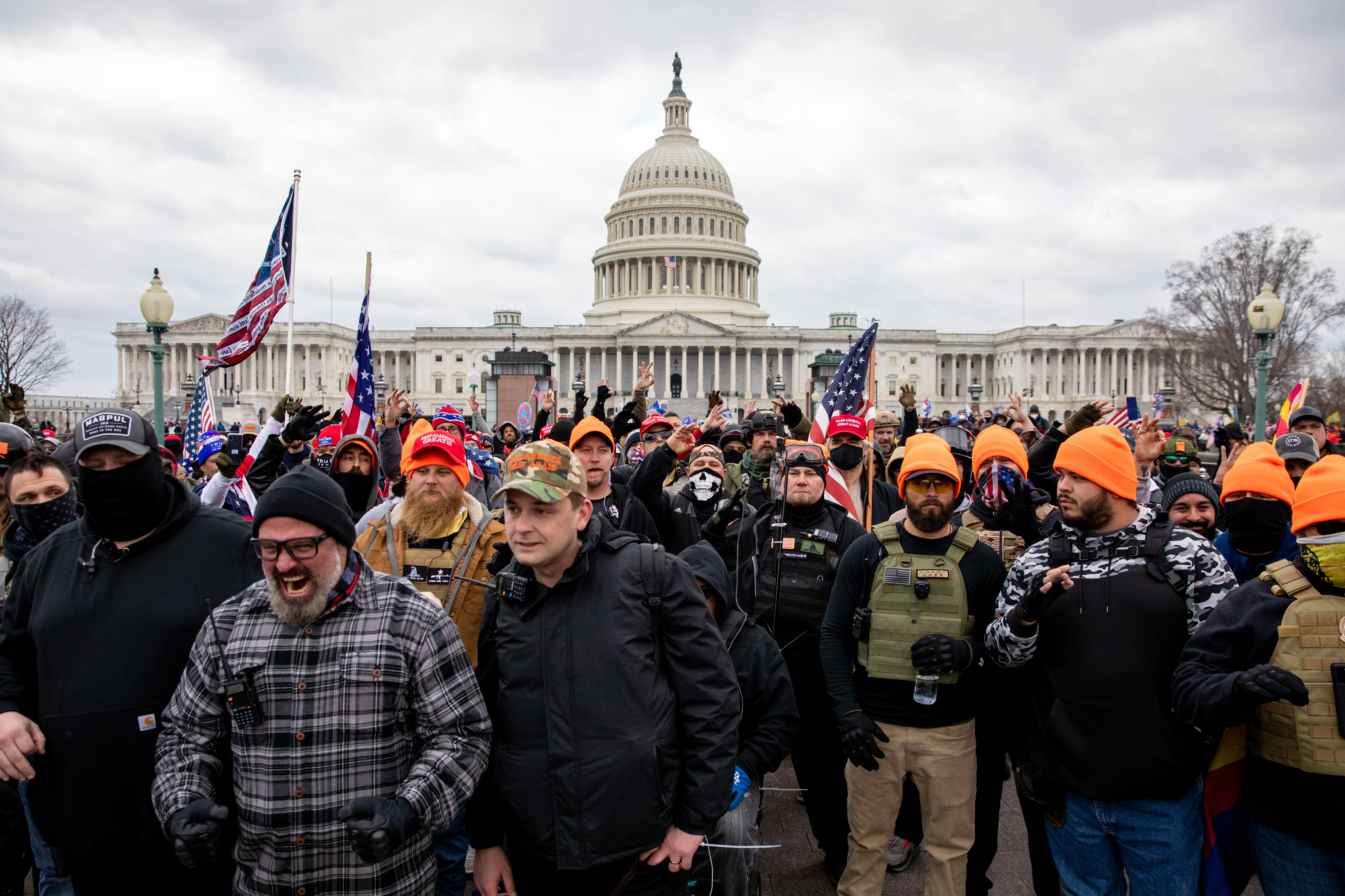 Members of the Proud Boys including Joseph Biggs (grey plaid flannel shirt) and Zach Rehl (camouflage cap) march near the U.S. Capitol on Jan. 6. 