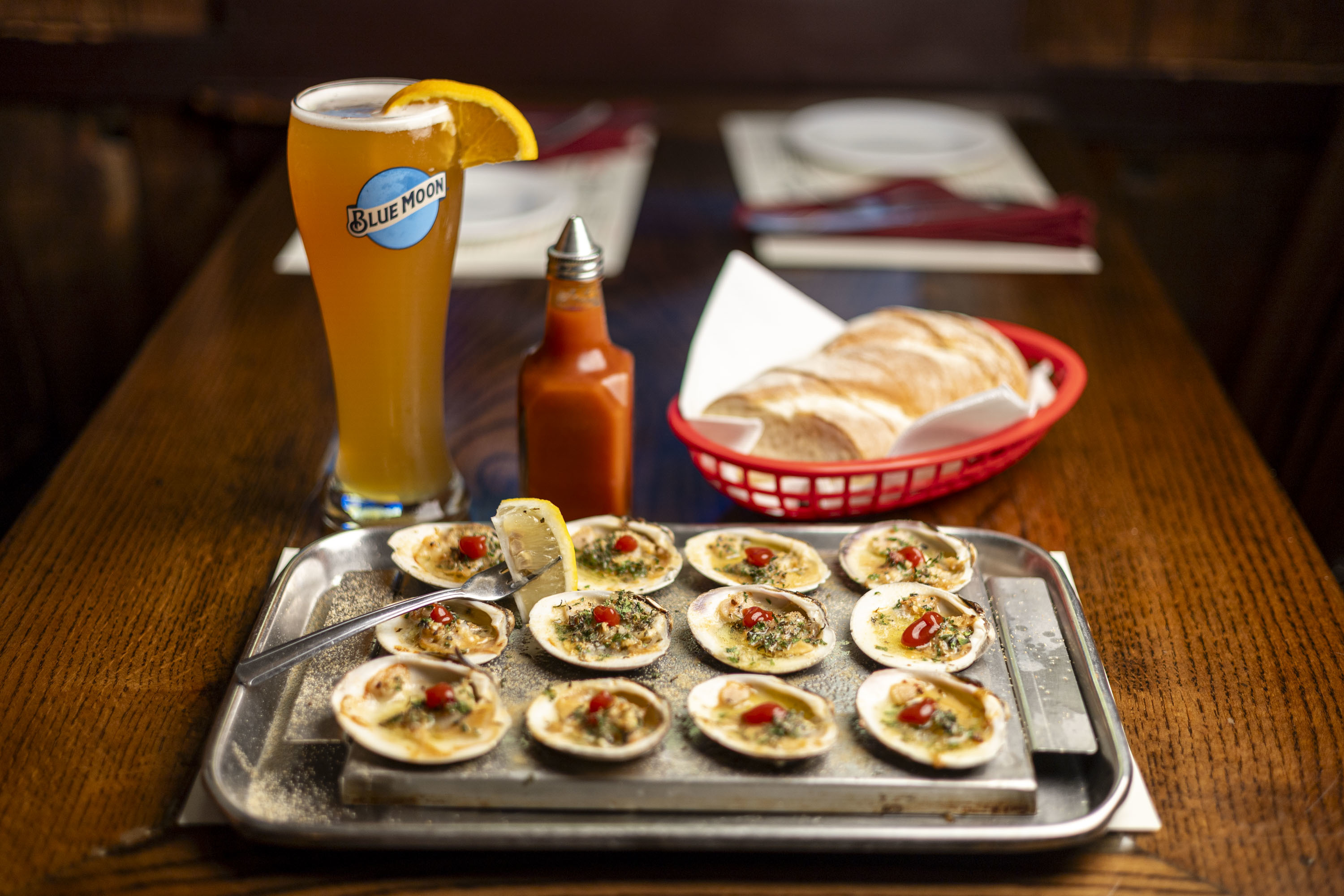 The baked clams with a glass of Blue Moon at the Clam Tavern in Clifton Heights, Pa., on Wednesday, Aug., 28, 2024. .