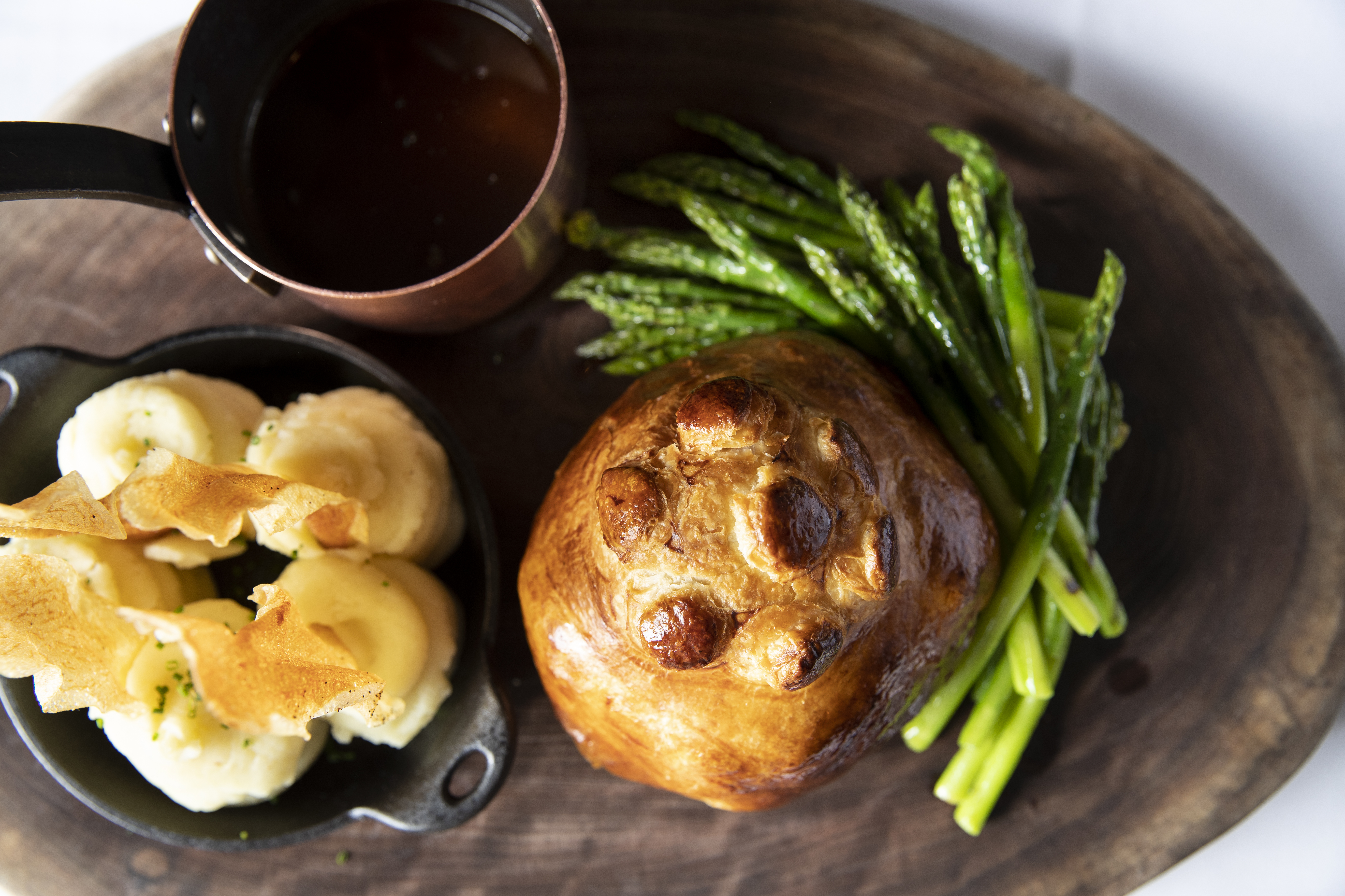 General Manager Zachary Bourne prepares the Beef Wellington for two tableside at Jansen in Philadelphia, Pa. on Tuesday, Aug. 8, 2023.