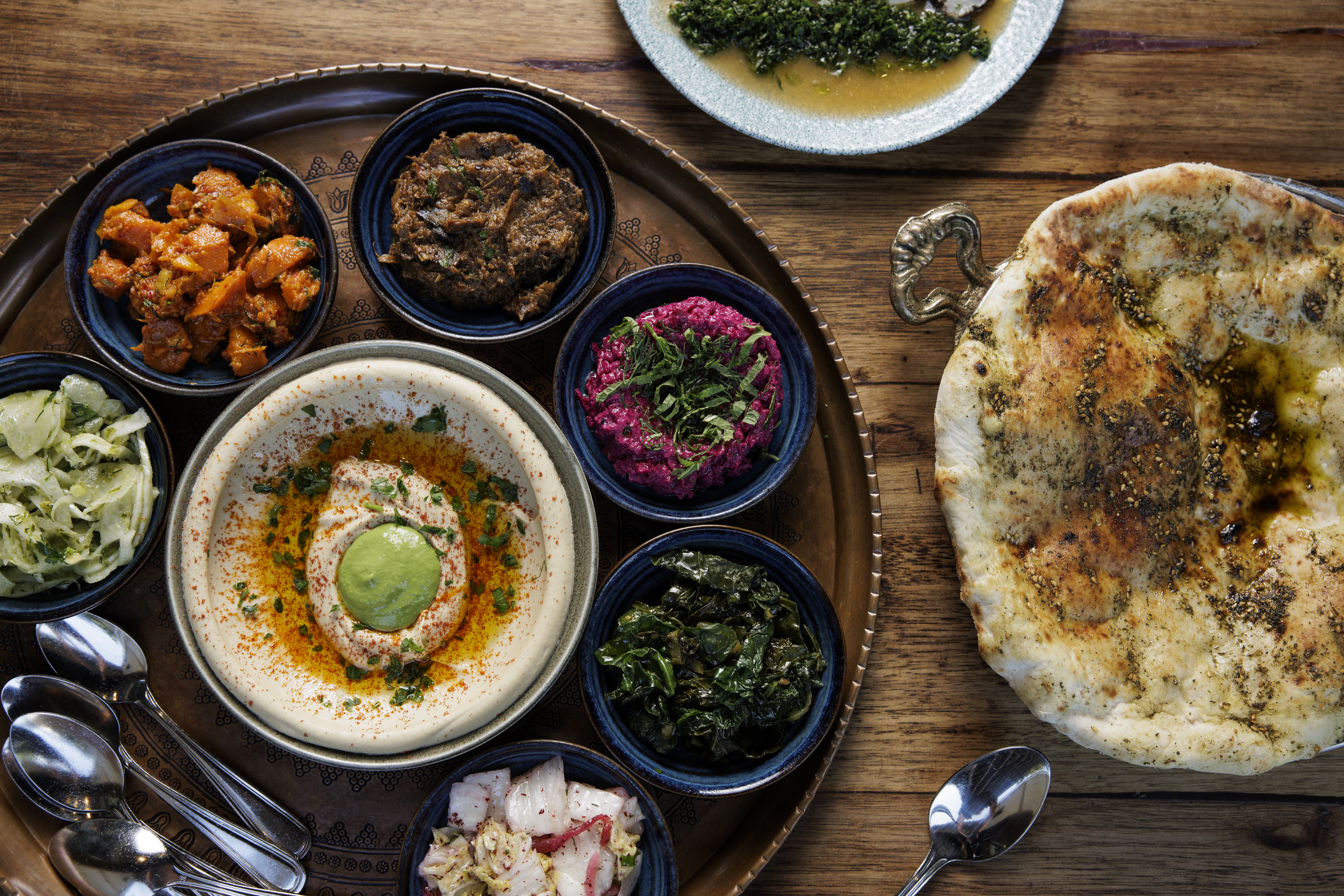 The Salatim with hummus-tehina and Laffa bread, right, at Zahav in Philadelphia, Pa. on Thursday, Sept. 12, 2024.