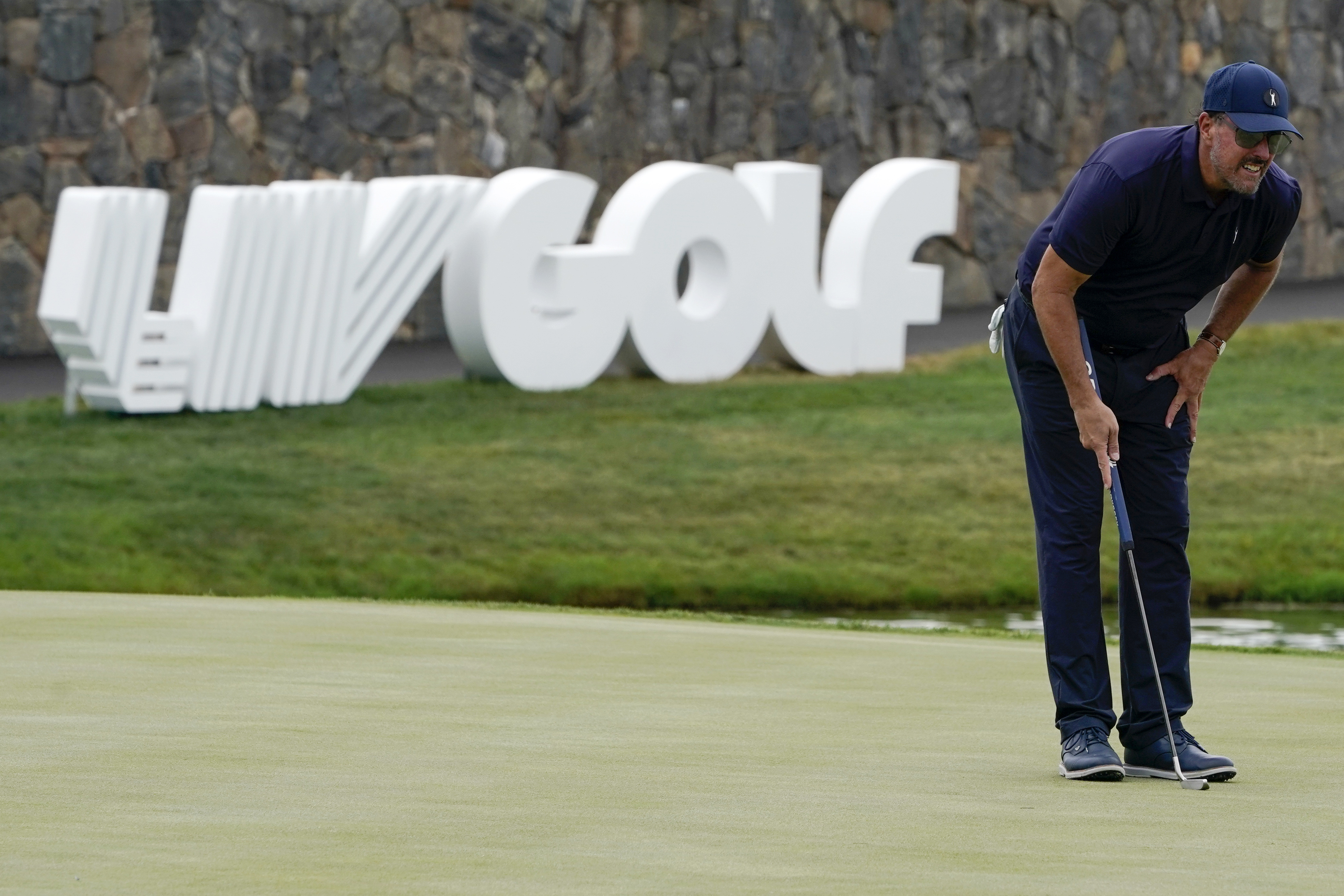 Greg Norman and players line up on the stage during the LIV Golf