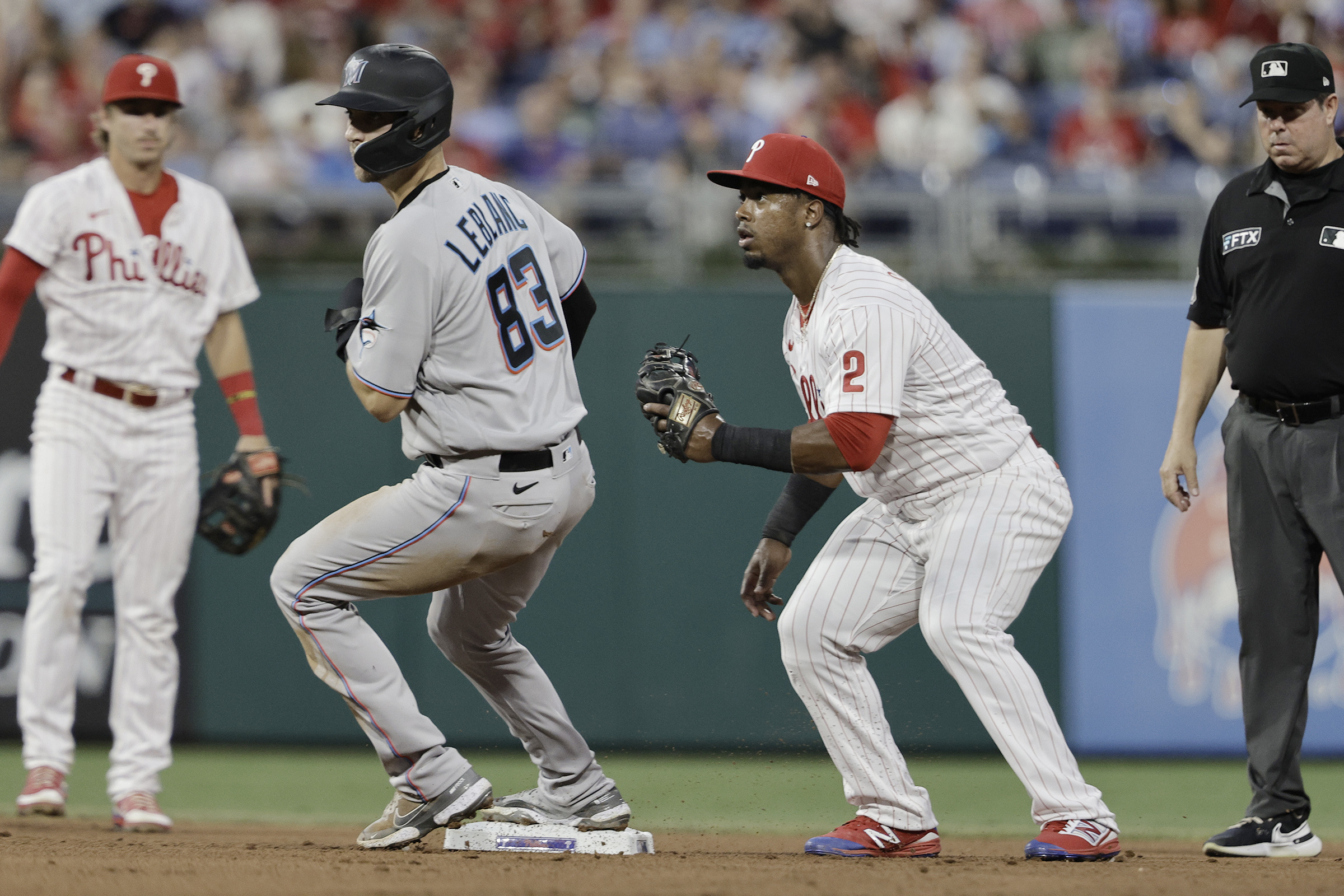 Philadelphia Phillies - The team celebrating winning today's game. They are  wearing white Phillies uniforms and hugging Bryson Stott.