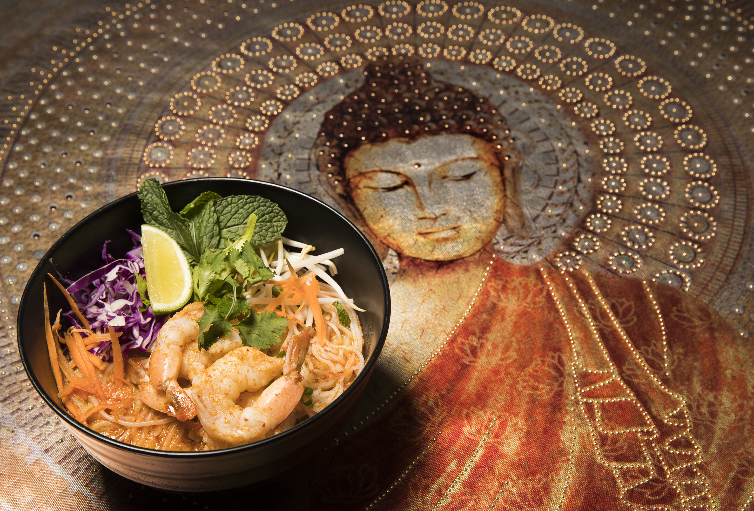 The Khaopoon King Soup with shrimp at Vientiane Bistro, a new Lao restaurant in Kensington on Nov. 24, 2018.  The painting of Buddha is from the walls of the restaurant. The Buddhism practiced in Laos is of the Theravada tradition.  CHARLES FOX / Staff Photographer