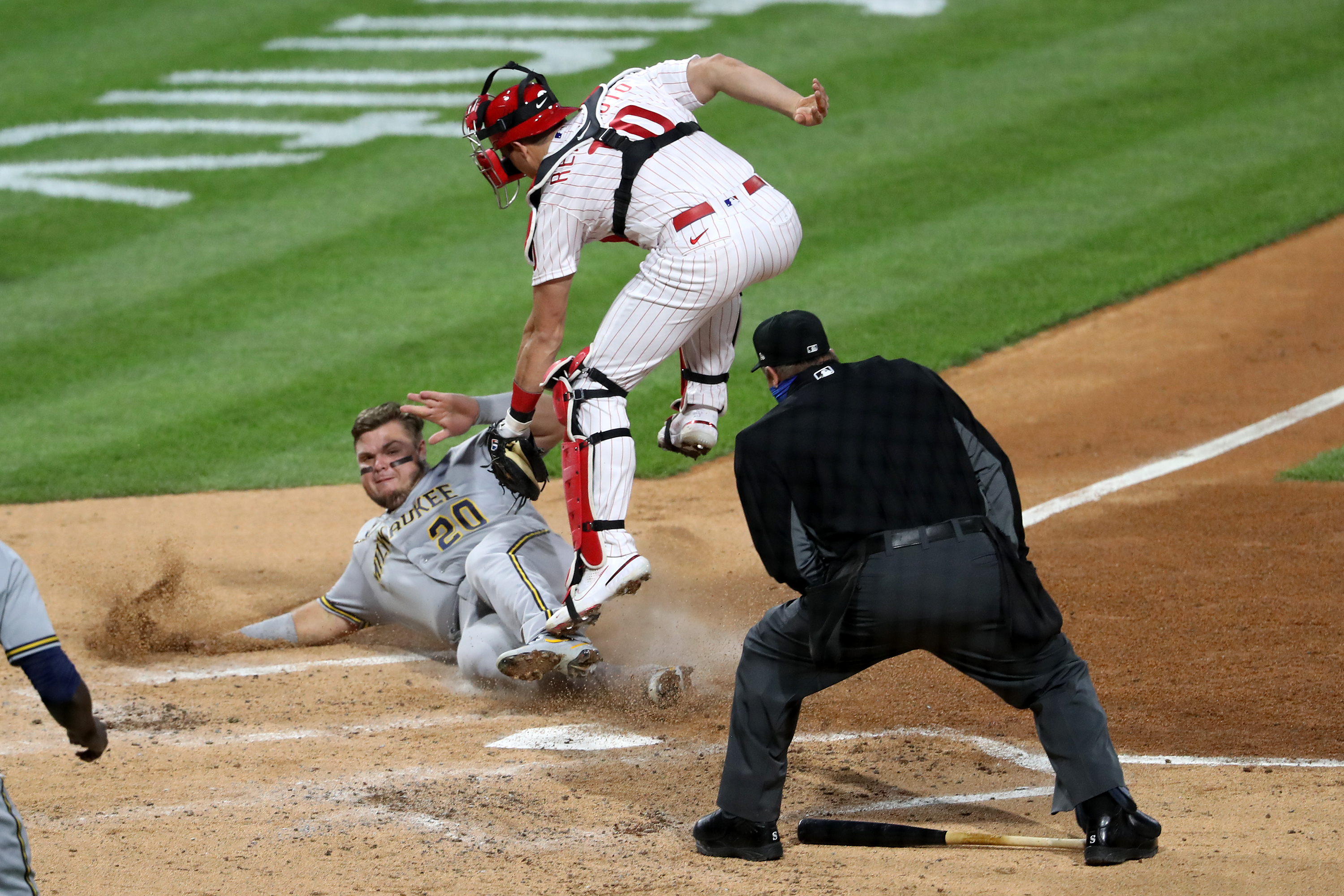 Peralta's arm, Taylor's bat lead Brewers past Reds