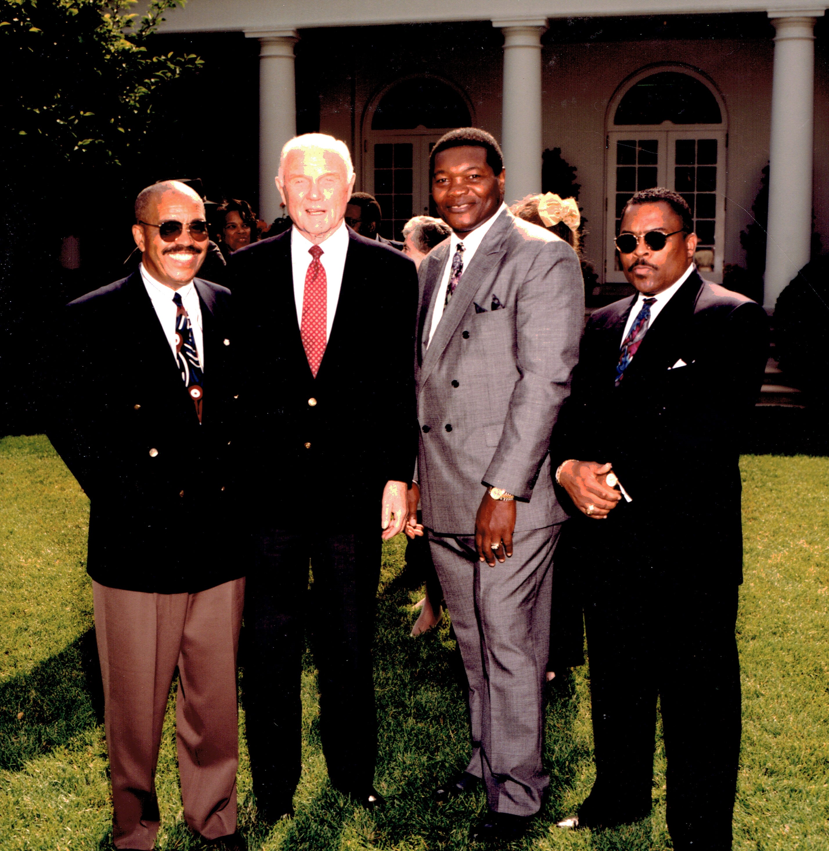 Central State track and field coach Josh Culbreath (left) is joined by U.S. Senator John Glenn (Ohio) and CSU football coach Billy Joe (next to Glenn) at the White House in 1994.