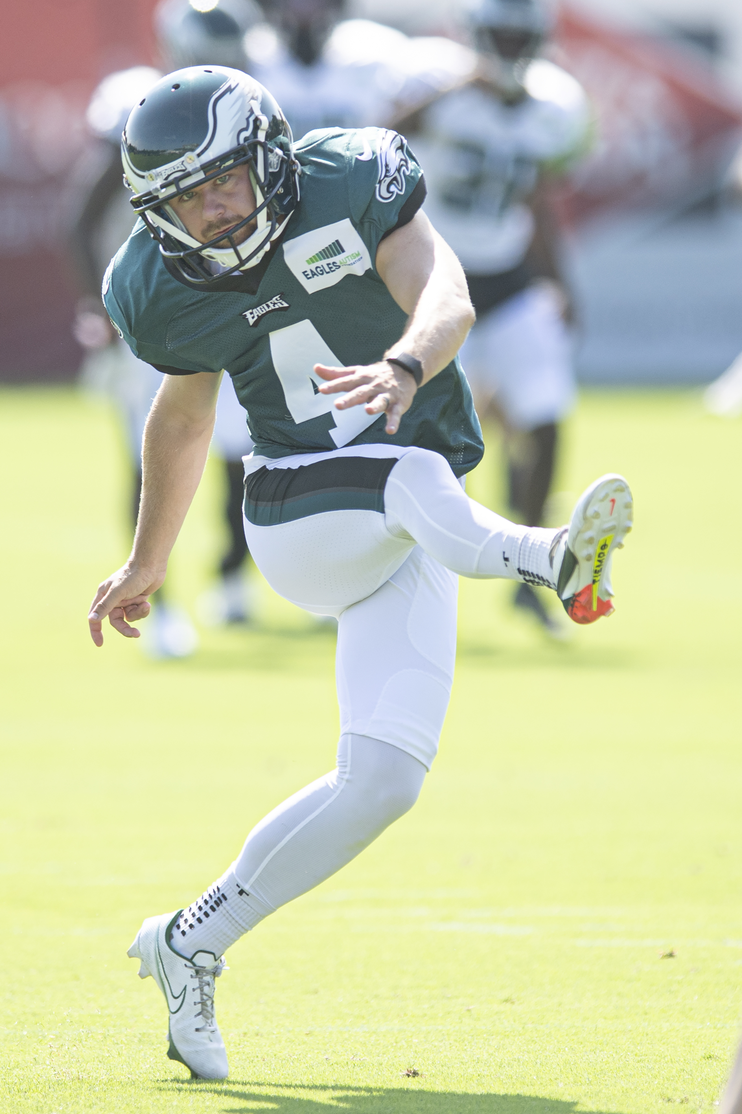 Member of the US military holds up the signed practice worm jersey of  Philadelphia Eagles quarterback Jalen Hurts for the Back Together  Saturday during practice at NFL football training camp, Saturday, July