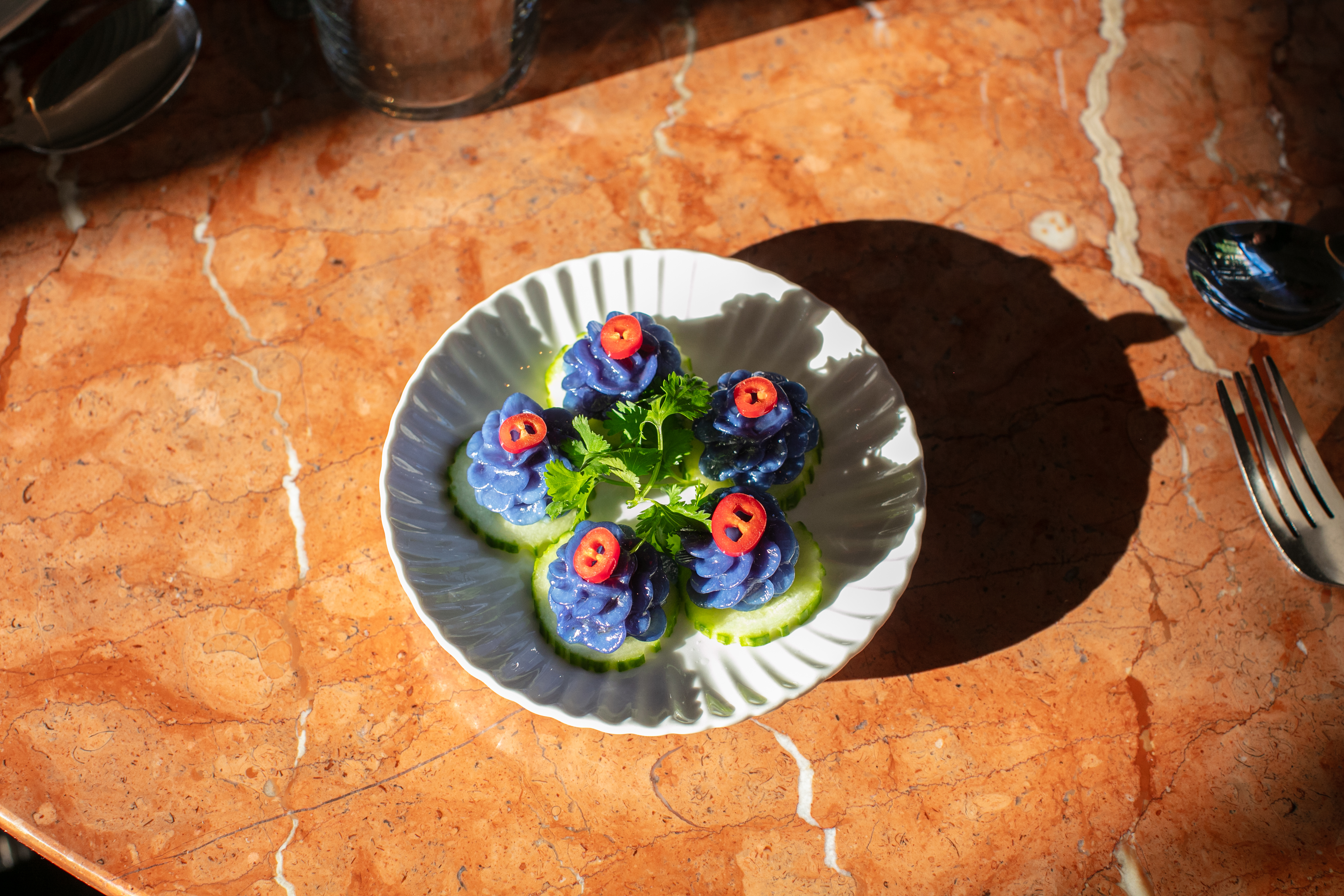 The Shaw Muang dumplings are five flower-shaped dumplings with ground chicken, cucumber and thai chili. Prepared and plated at Kalaya in Fishtown on August 22, 2024.