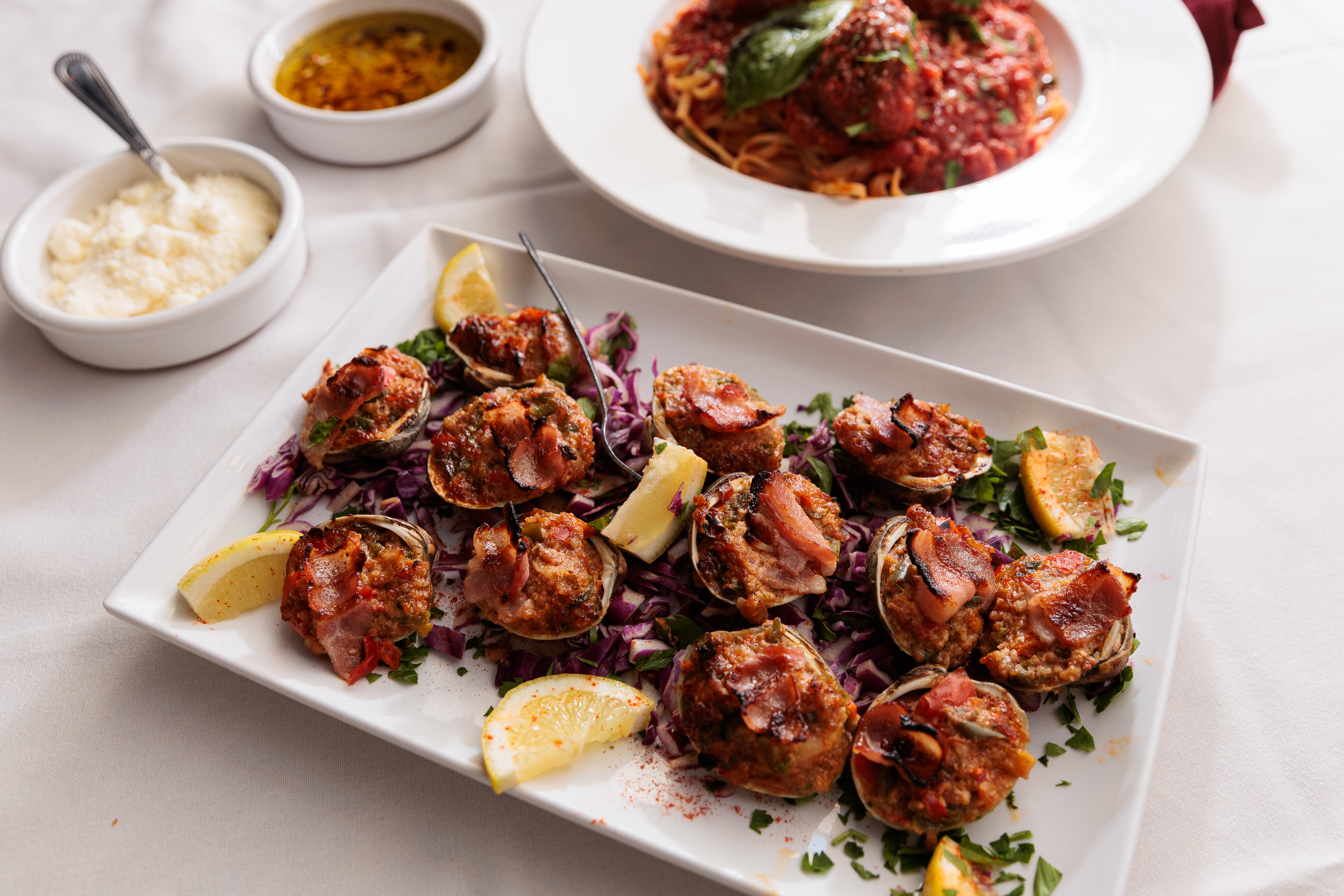 Clams casino and Linquine with meatballs from Scannichio’s on Friday, Sept. 13, 2024, in Philadelphia .