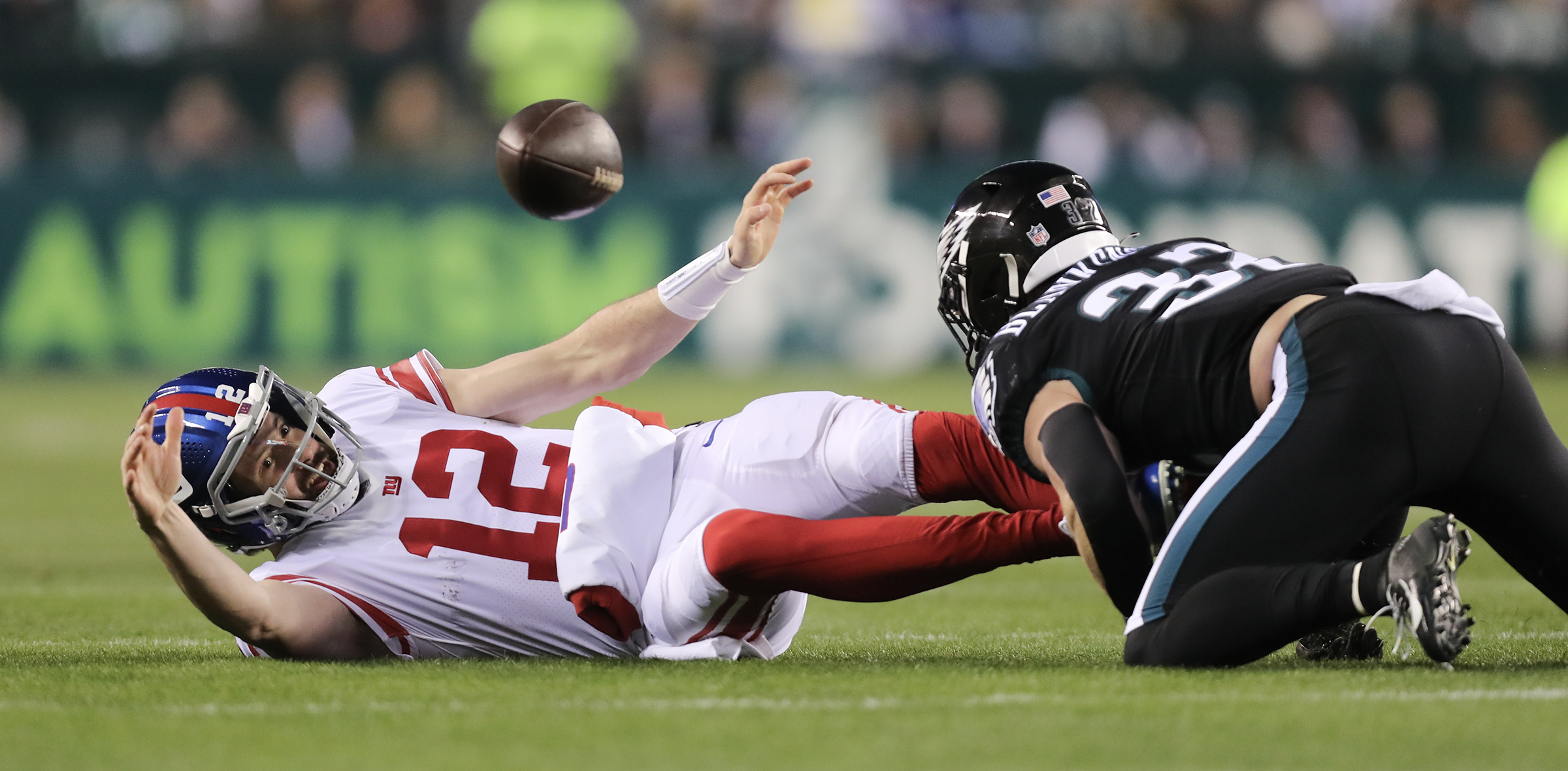 New York Giants quarterback Davis Webb (12) runs over Philadelphia Eagles  safety Reed Blankenship (32) and scores a touchdown on a 14-yard run during  the fourth quarter of an NFL football game