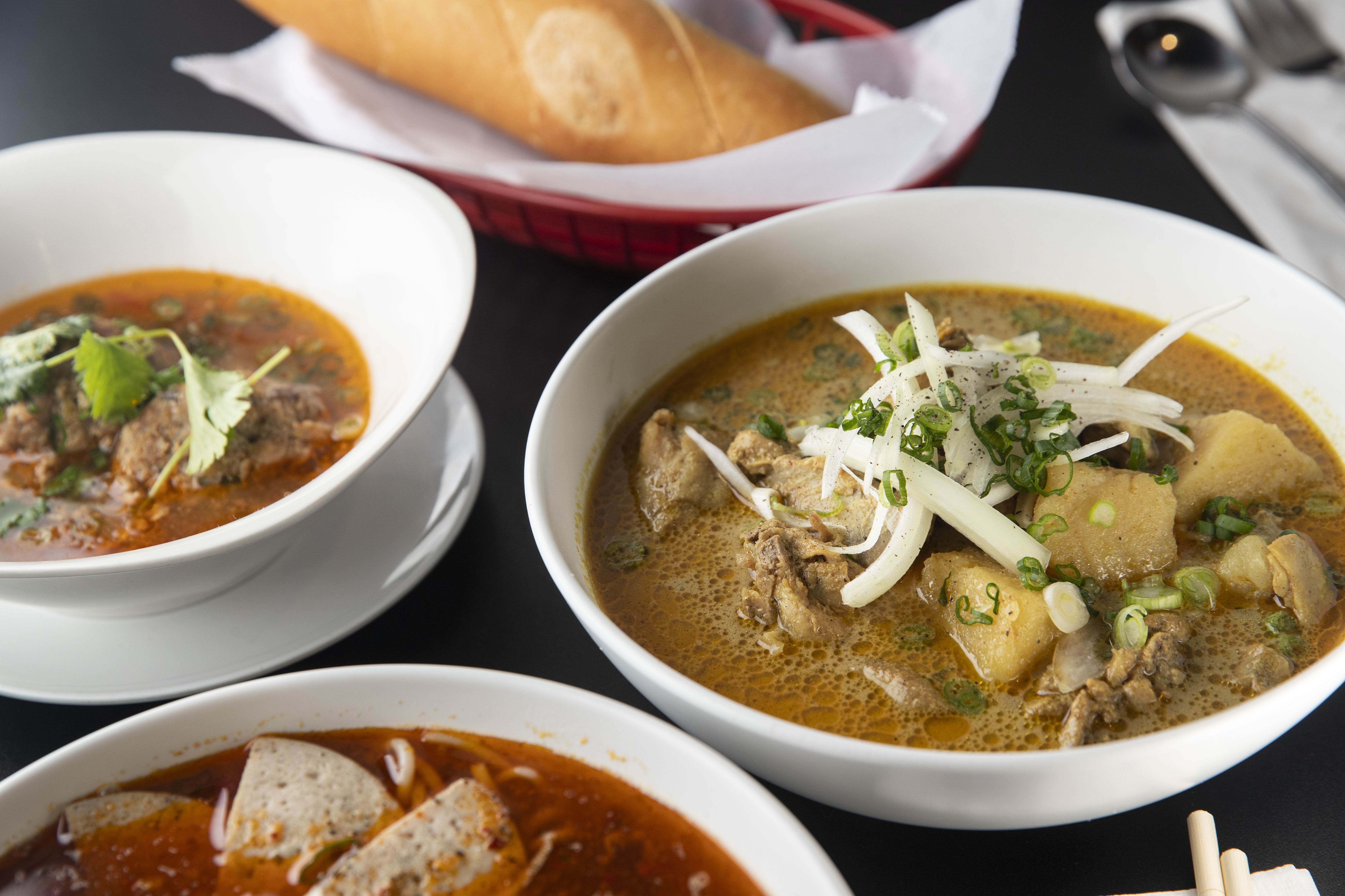 (left to right) The Banh Mi Xiu May, Bun Bo Hue Dac Biet and the chicken curry at Cafe Nhan in Philadelphia, Pa. on Monday, February 7, 2022. Cafe Nhan is located at 1606 W Passyunk Avenue.