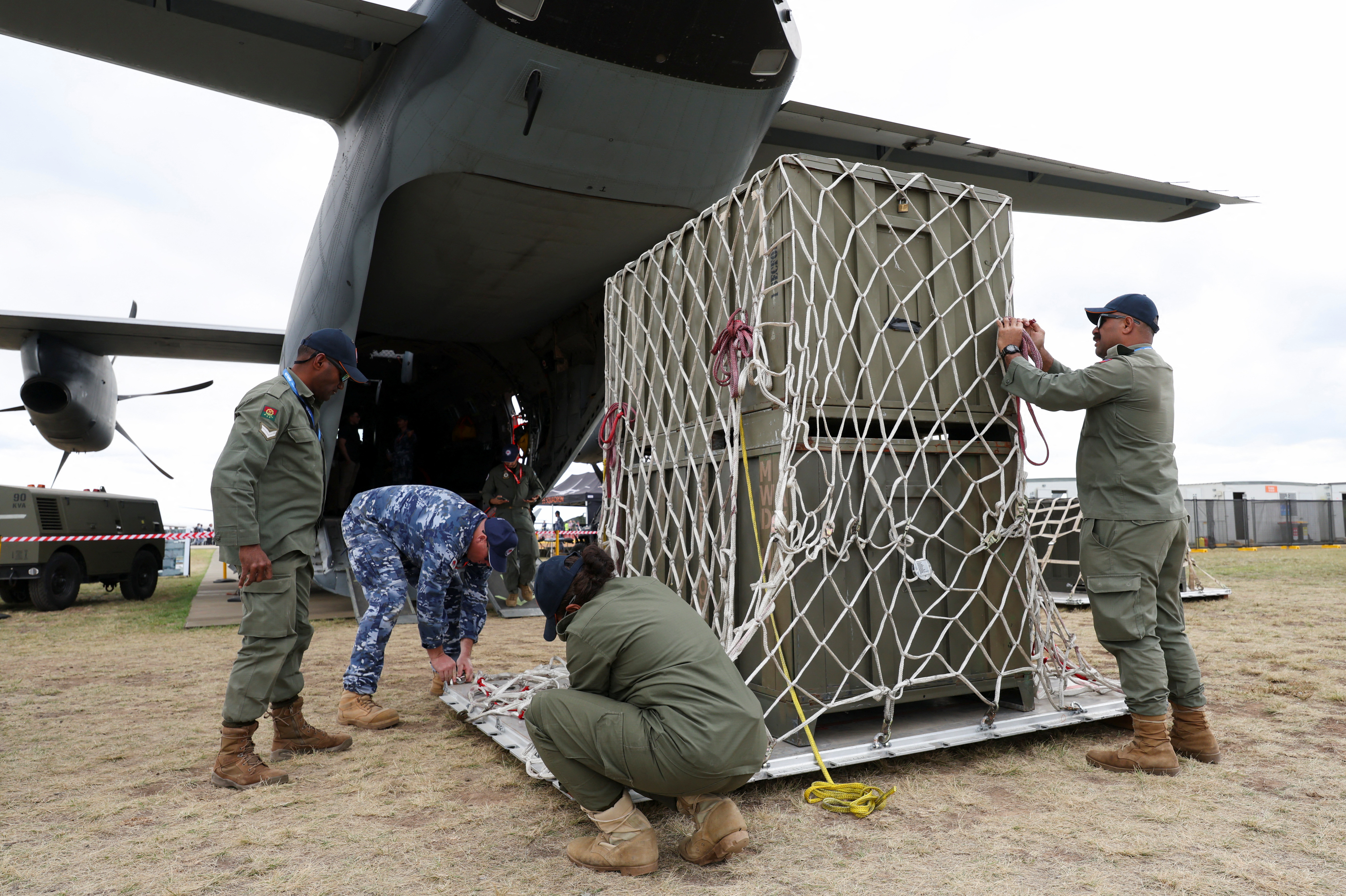 Republic of Fiji Military Forces personnel practice servicing cargo for transport with a member of the Royal Australian Air Force during the Australian International Airshow in Avalon, Australia March 26, 2025.
