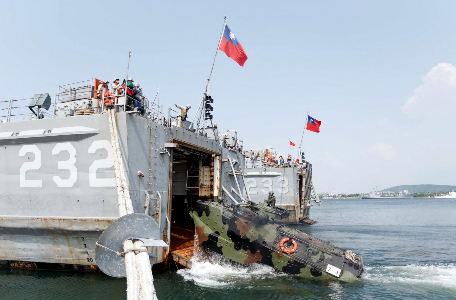 This photograph released by Taiwan's Military News Agency shows soldiers driving a personnel vehicle into a warship near Taiwan during the annual Han Kuang drill on Aug. 22, 2016.
