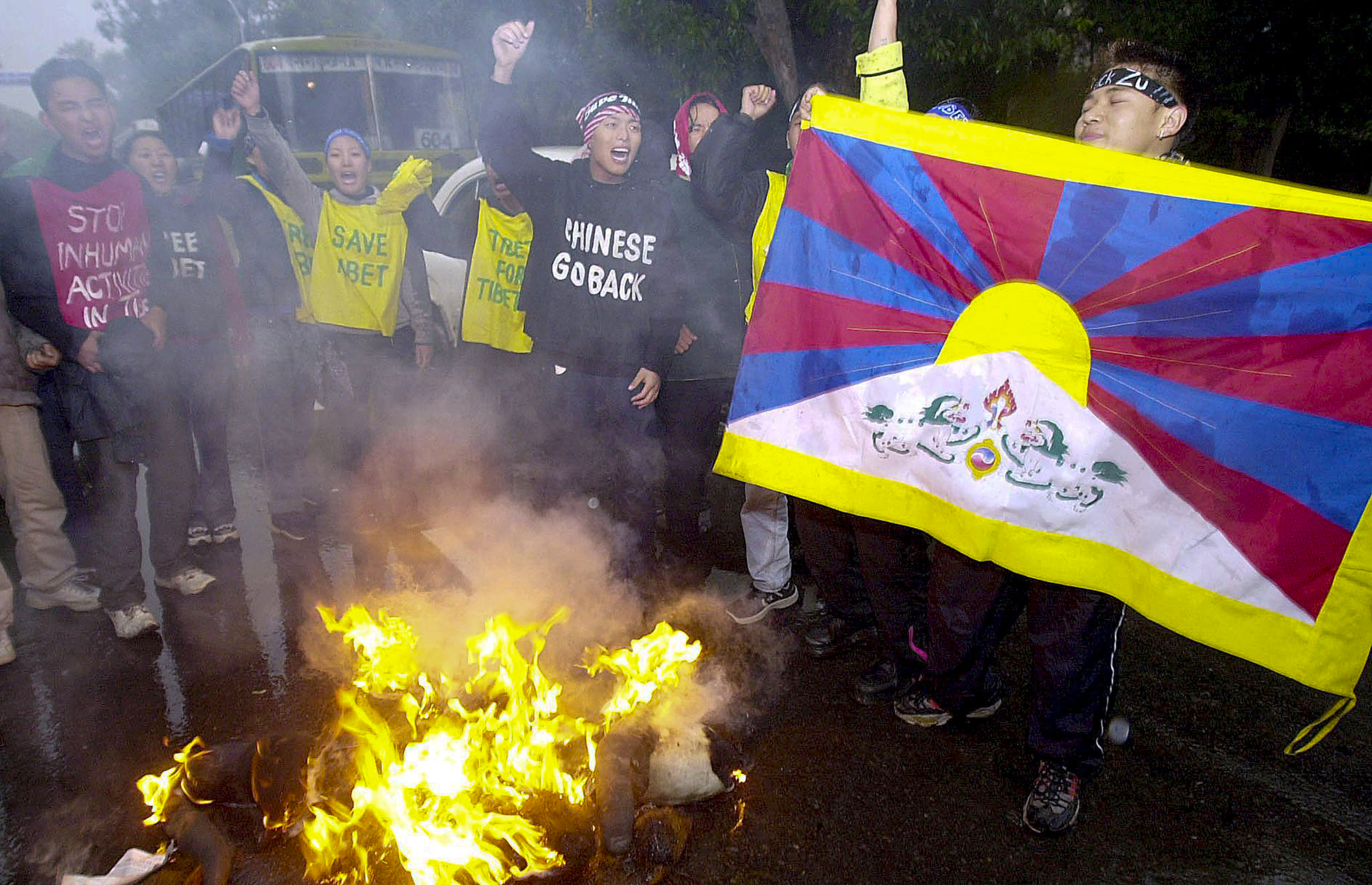 A Tibetan demonstrator displays a Tibetan flag as they protest Chinese Premier Zhu Rongji near the Chinese embassy in New Delhi, Jan. 15, 2002.