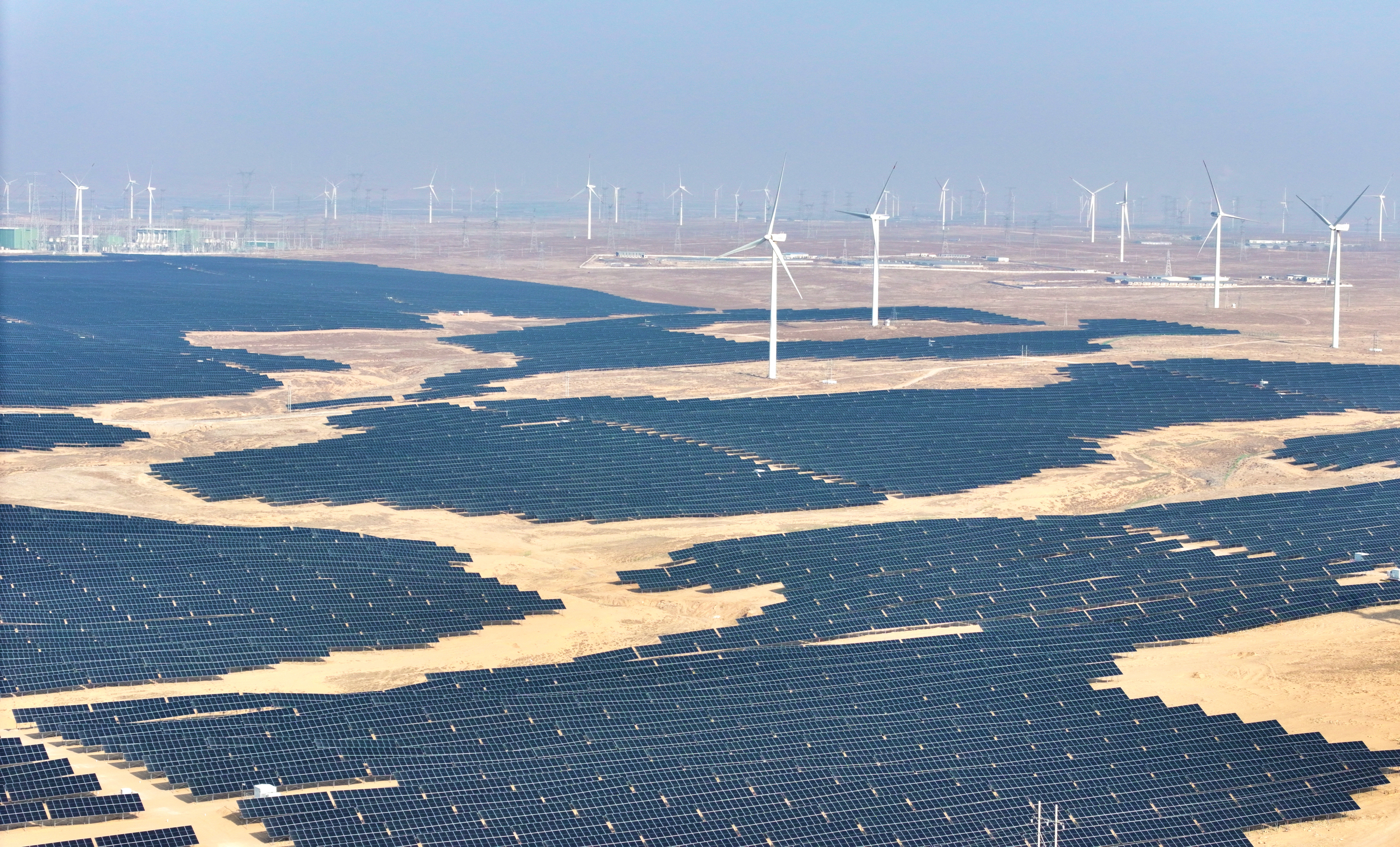 Solar panels and wind turbines at a renewable energy farm in Lingwu, in China's northern Ningxia region, Dec. 22, 2025