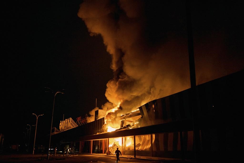 Ukrainian State Emergency Service firefighters put out a fire after Russian shelling hit a shopping center in Kherson, Ukraine, Friday, Feb. 3, 2023.