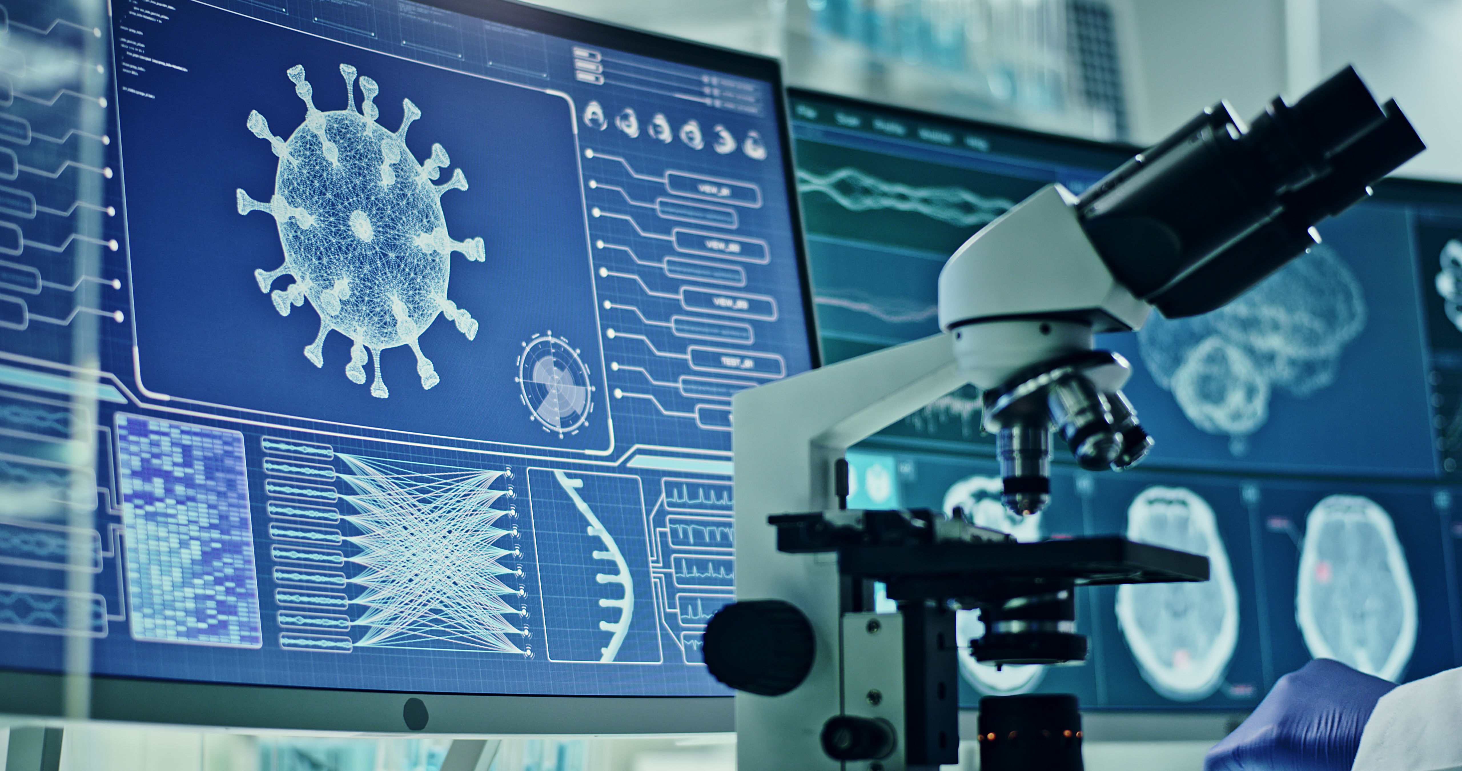 Computer screens in laboratory. Brain scans and coronavirus research