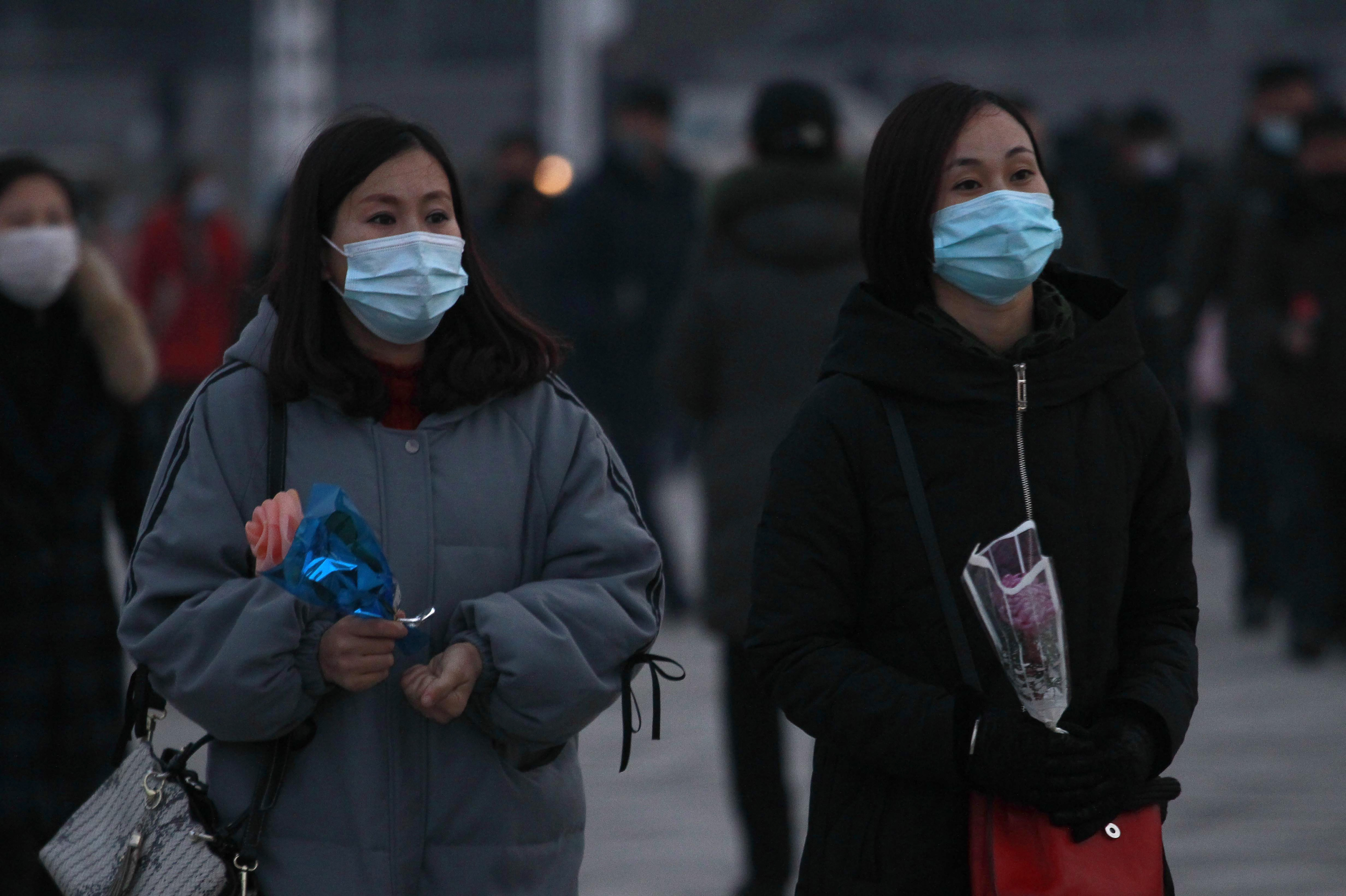 Citizens visit the bronze statues of their late leaders Kim Il Sung and Kim Jong Il on Mansu Hill in Pyongyang, North Korea Thursday, Dec. 16, 2021, on the occasion of 10th anniversary of demise of Kim Jong Il. (AP Photo/Jon Chol Jin)
