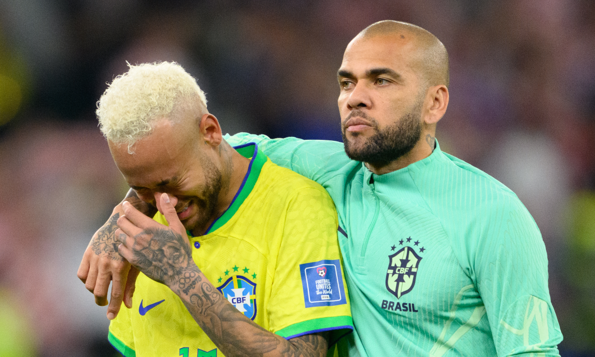 09 December 2022, Qatar, Al-Rajjan: Soccer: World Cup, Croatia - Brazil, final round, quarterfinal, Education City Stadium. Brazil's Dani Alves (r) comforts the crying Brazil's Neymar after the match. Photo: Robert Michael/dpa (Photo by Robert Michael/picture alliance via Getty Images)