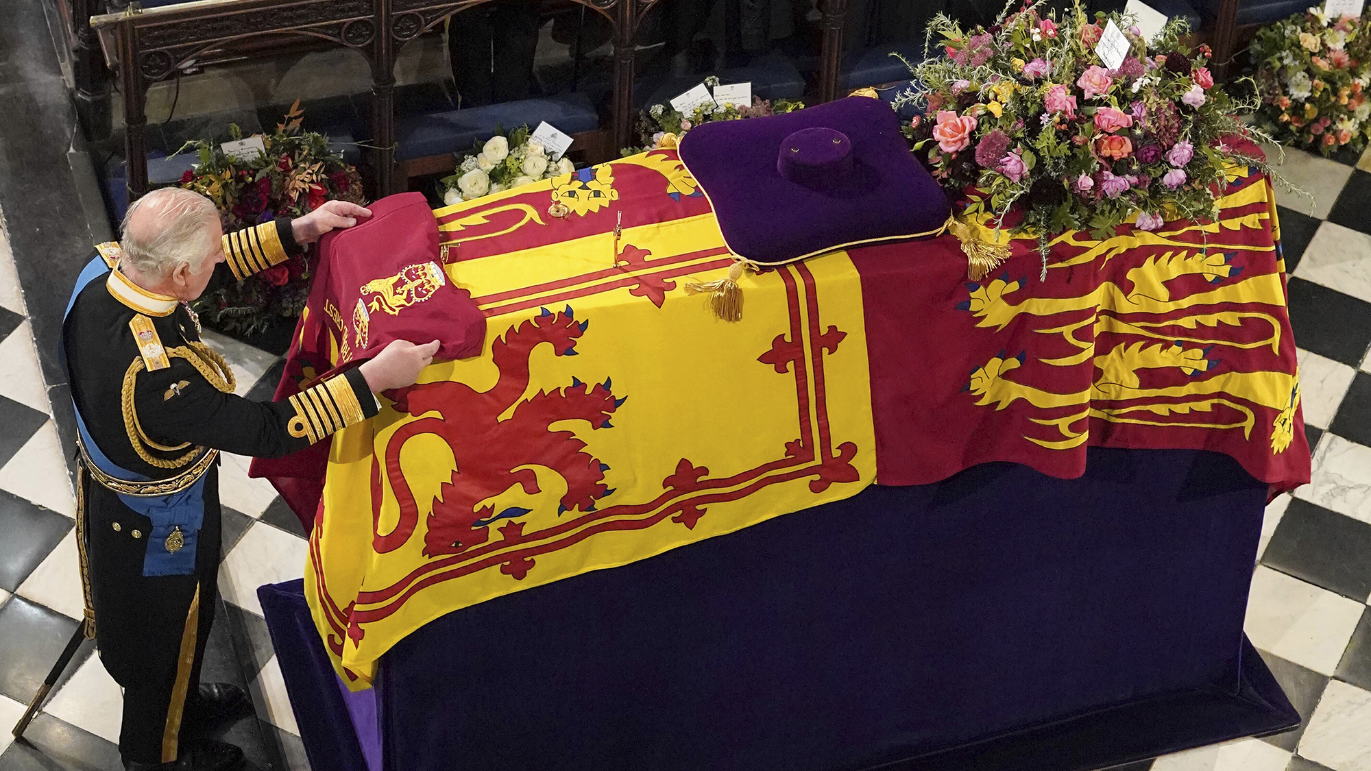 King Charles III places the Queen's Company Camp Colour of the Grenadier Guards on the coffin at the Committal Service for Queen Elizabeth II, held at St George's Chapel in Windsor Castle, Monday Sept. 19, 2022. (Jonathan Brady/Pool Photo via AP)