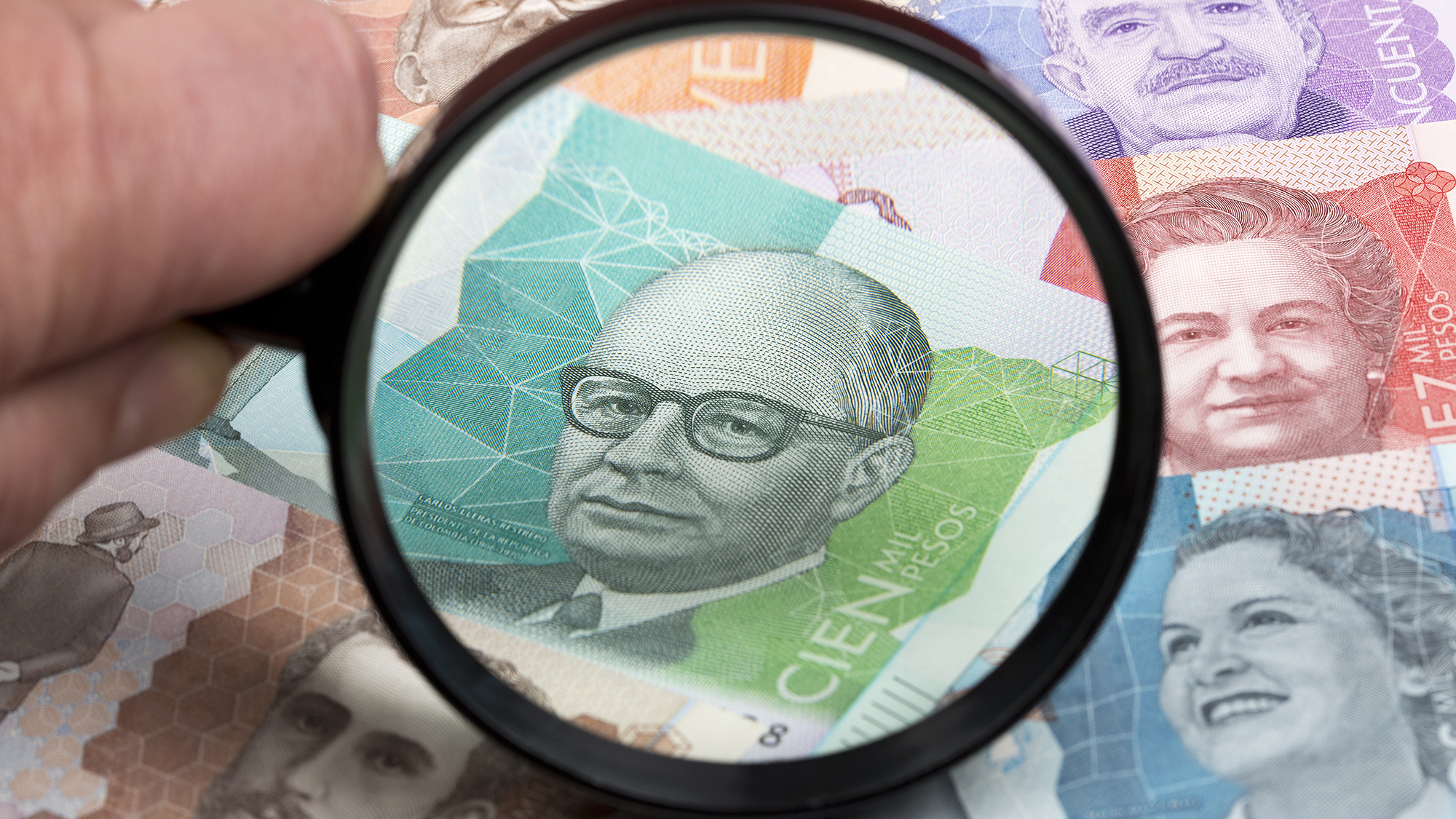 Peso colombiano en una lupa un trasfondo empresarial