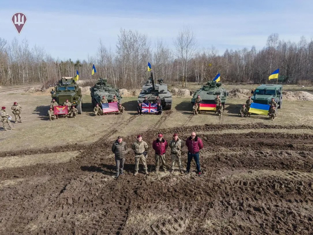 Ukraine's Defence Minister Oleksii Reznikov and Commander of the Air Assault Forces Maksym Myrhorodskyi pose for a picture in front of British Challenged 2 main battle tank, U.S. Stryker and Cougar armoured personnel carriers and German Marder infantry fighting vehicle, amid Russia's attack on Ukraine, in an unknown location in Ukraine, in this handout picture released March 27, 2023. Press Service of the Defence Ministry of Ukraine/Handout via REUTERS ATTENTION EDITORS - THIS IMAGE HAS BEEN SUPPLIED BY A THIRD PARTY.