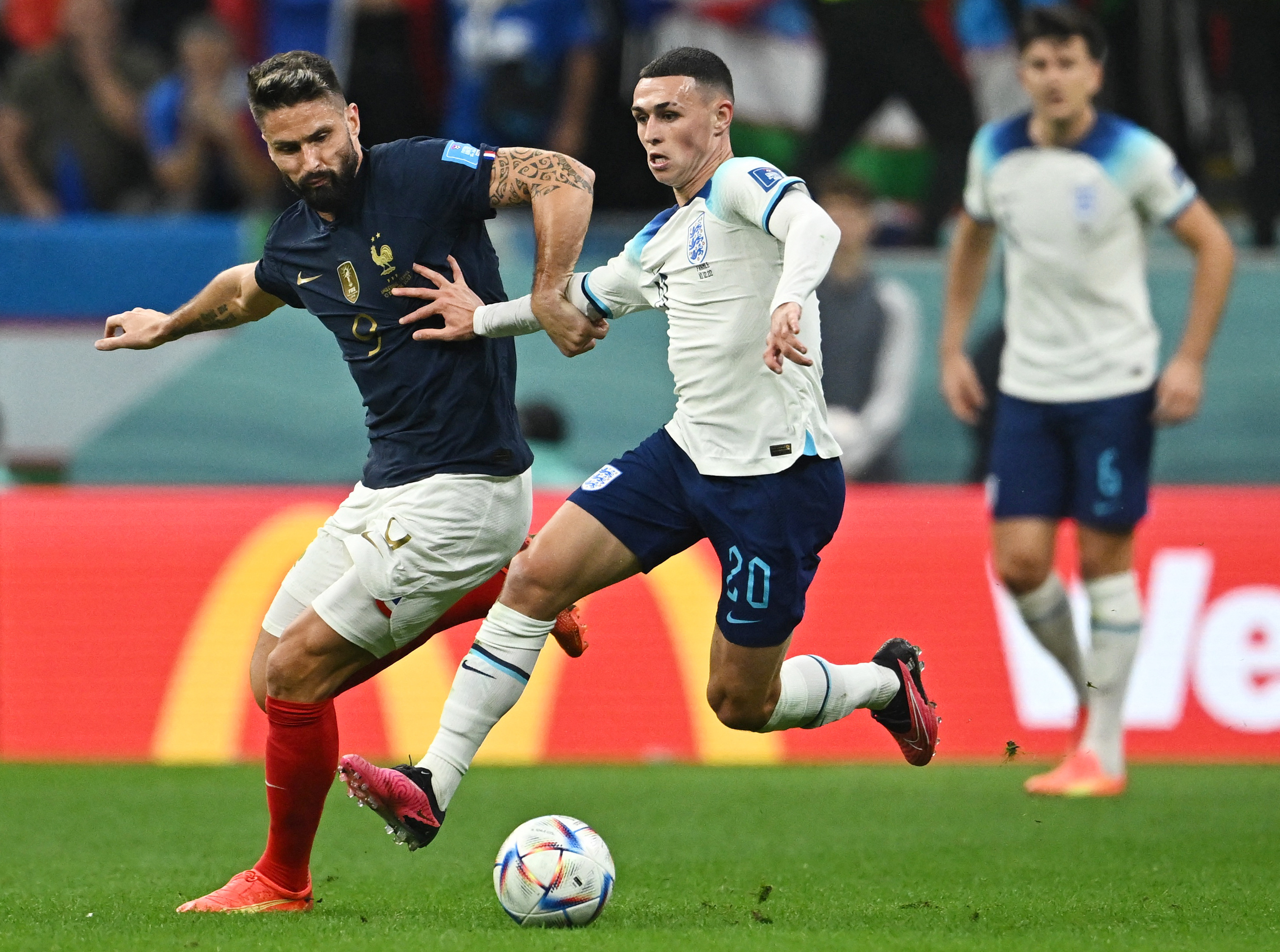 Soccer Football - FIFA World Cup Qatar 2022 - Quarter Final - England v France - Al Bayt Stadium, Al Khor, Qatar - December 10, 2022 France's Olivier Giroud in action with England's Phil Foden REUTERS/Dylan Martinez