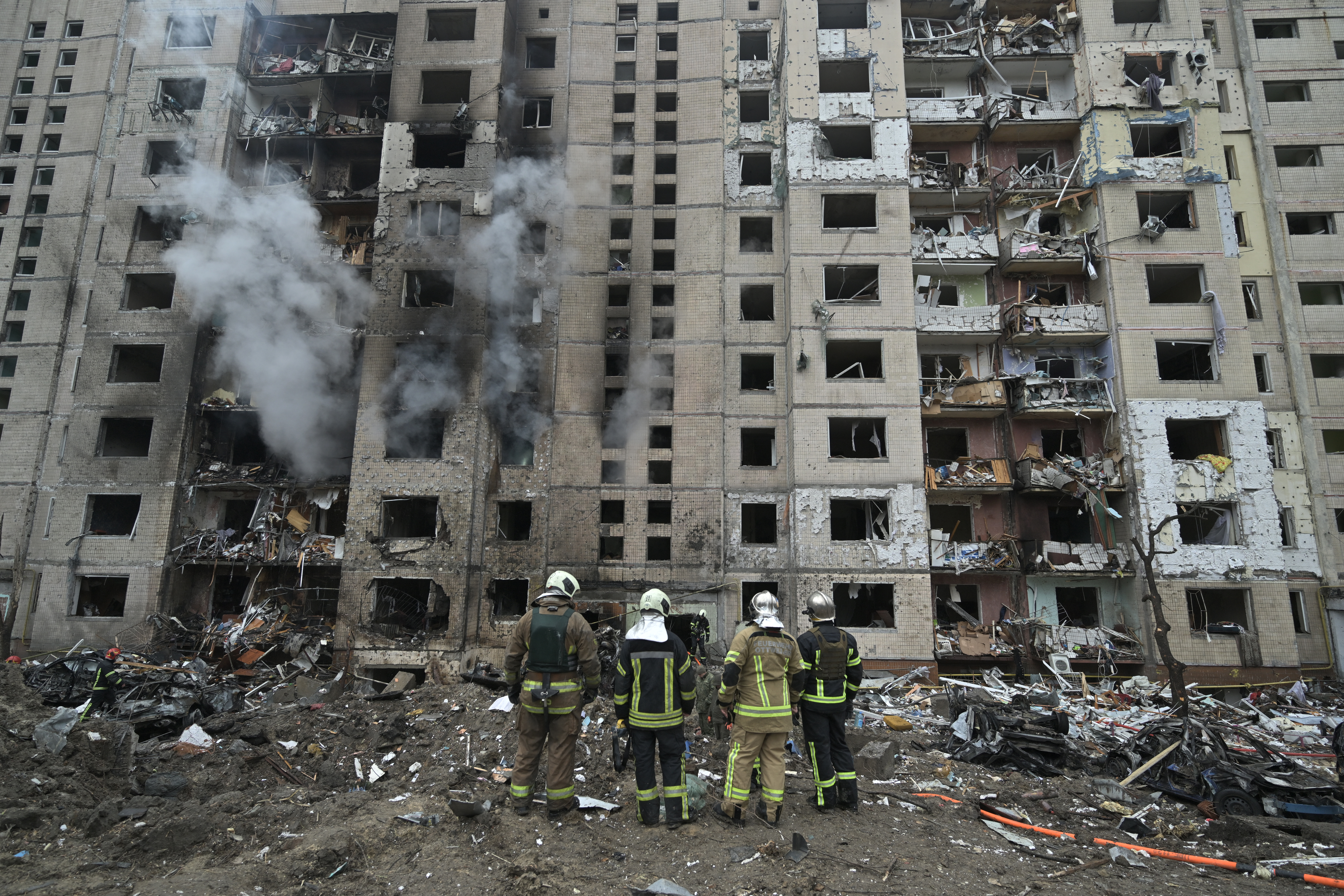 Firefighters work in a multi-storey residential building destroyed by a missile attack in central Kyiv, on January 2, 2024, amid the Russian invasion of Ukraine. Russian strikes on Ukraine's capital, Kyiv, and the northeastern city of Kharkiv killed at least five people. Russian President Vladimir Putin on January 1, 2024 vowed to intensify strikes on Ukraine. The military campaign has dragged on for nearly two years. (Photo by Genya SAVILOV / AFP)
