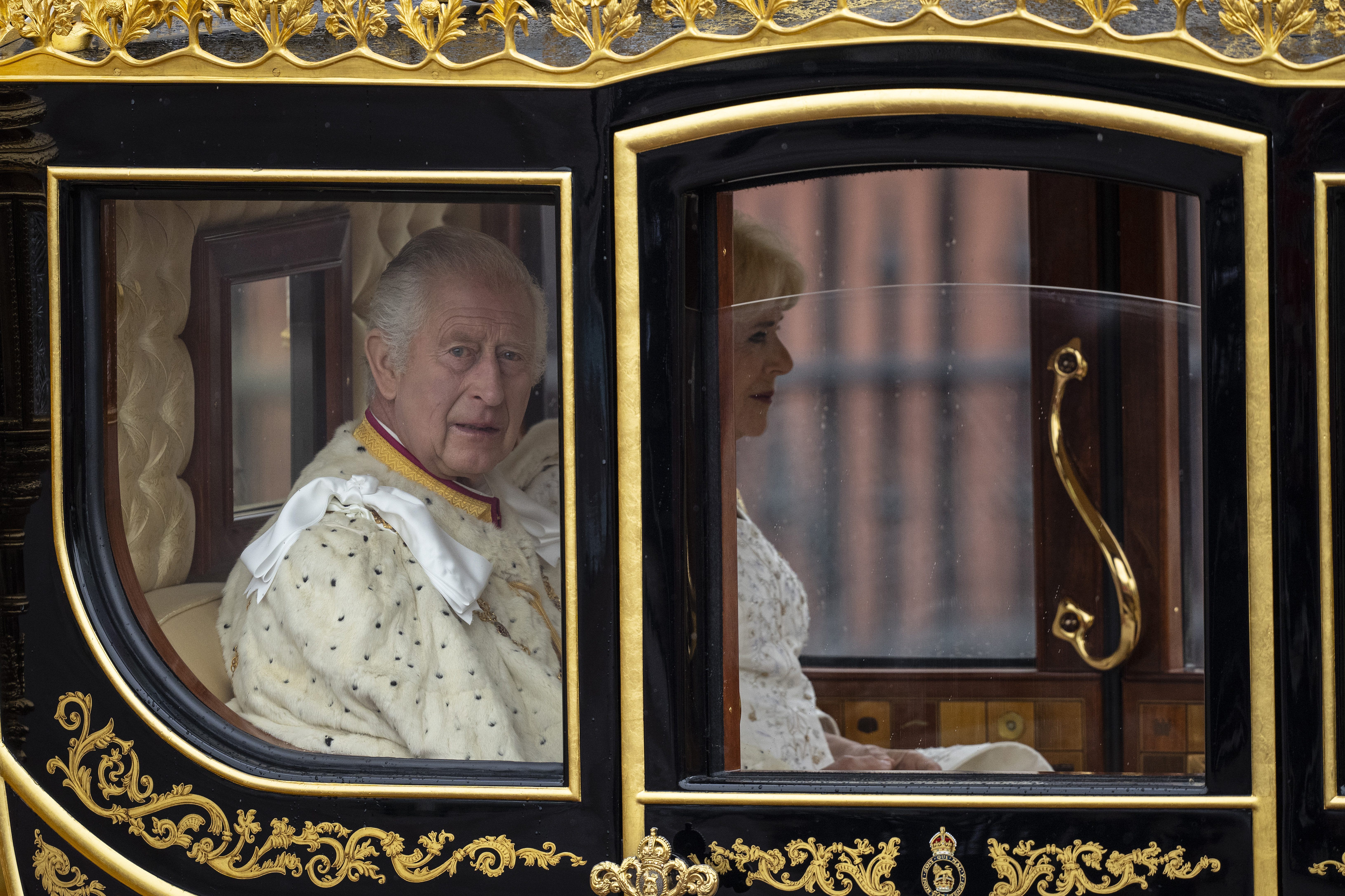 LONDON, ENGLAND - MAY 06: King Charles III and Queen Camilla travelling in the Diamond Jubilee Coach, built in 2012 to commemorate the 60th anniversary of the reign of Queen Elizabeth II, leave Buckingham Palace ahead of the Coronation of King Charles III and Queen Camilla on May 06, 2023 in London, England. The Coronation of Charles III and his wife, Camilla, as King and Queen of the United Kingdom of Great Britain and Northern Ireland, and the other Commonwealth realms takes place at Westminster Abbey today. Charles acceded to the throne on 8 September 2022, upon the death of his mother, Elizabeth II. (Photo by Christopher Furlong/Getty Images)