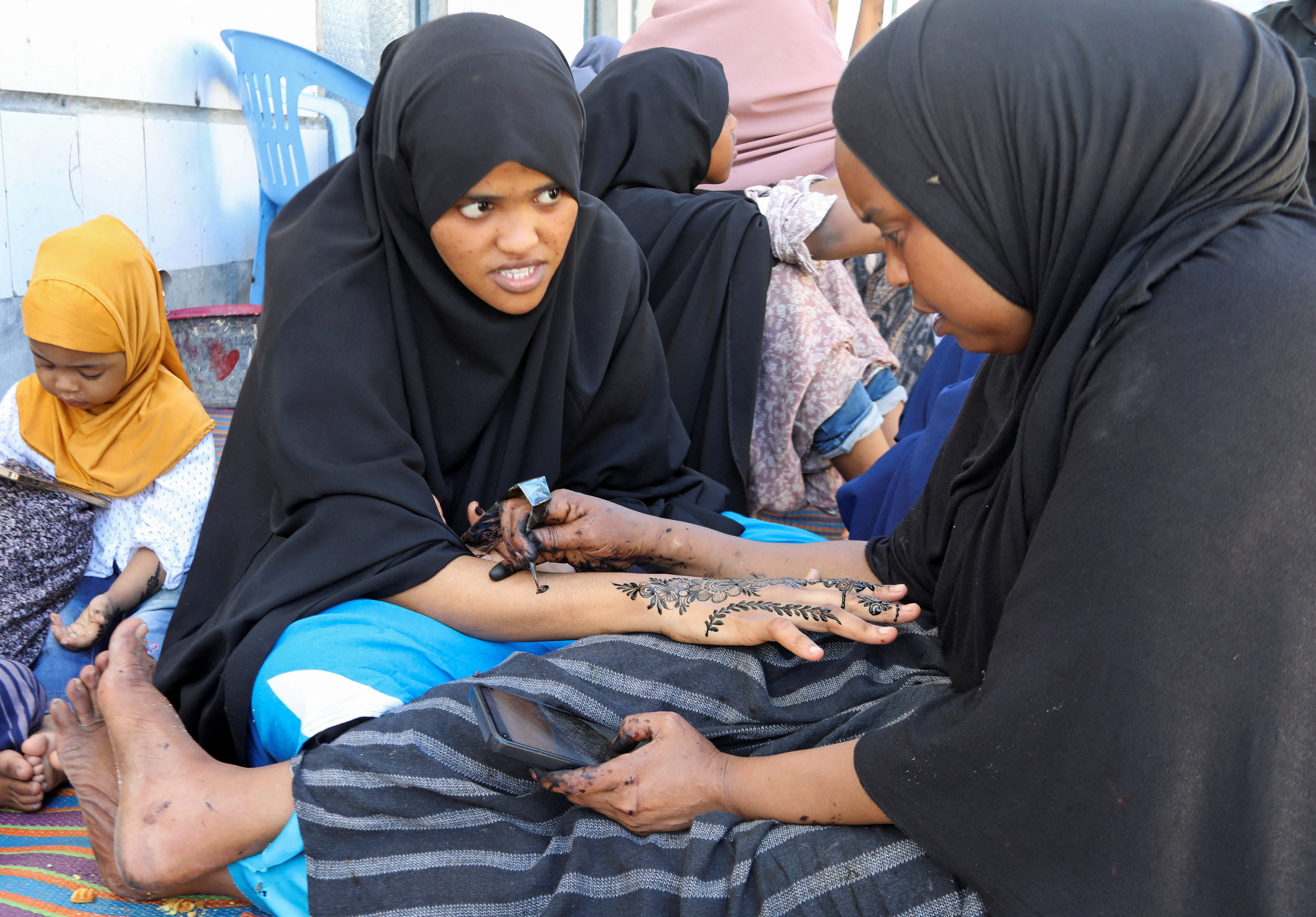 Somalian women apply henna decorations, during preparations ahead of Eid al-Fitr in Mogadishu, Somalia April 20, 2023. REUTERS/Feisal Omar