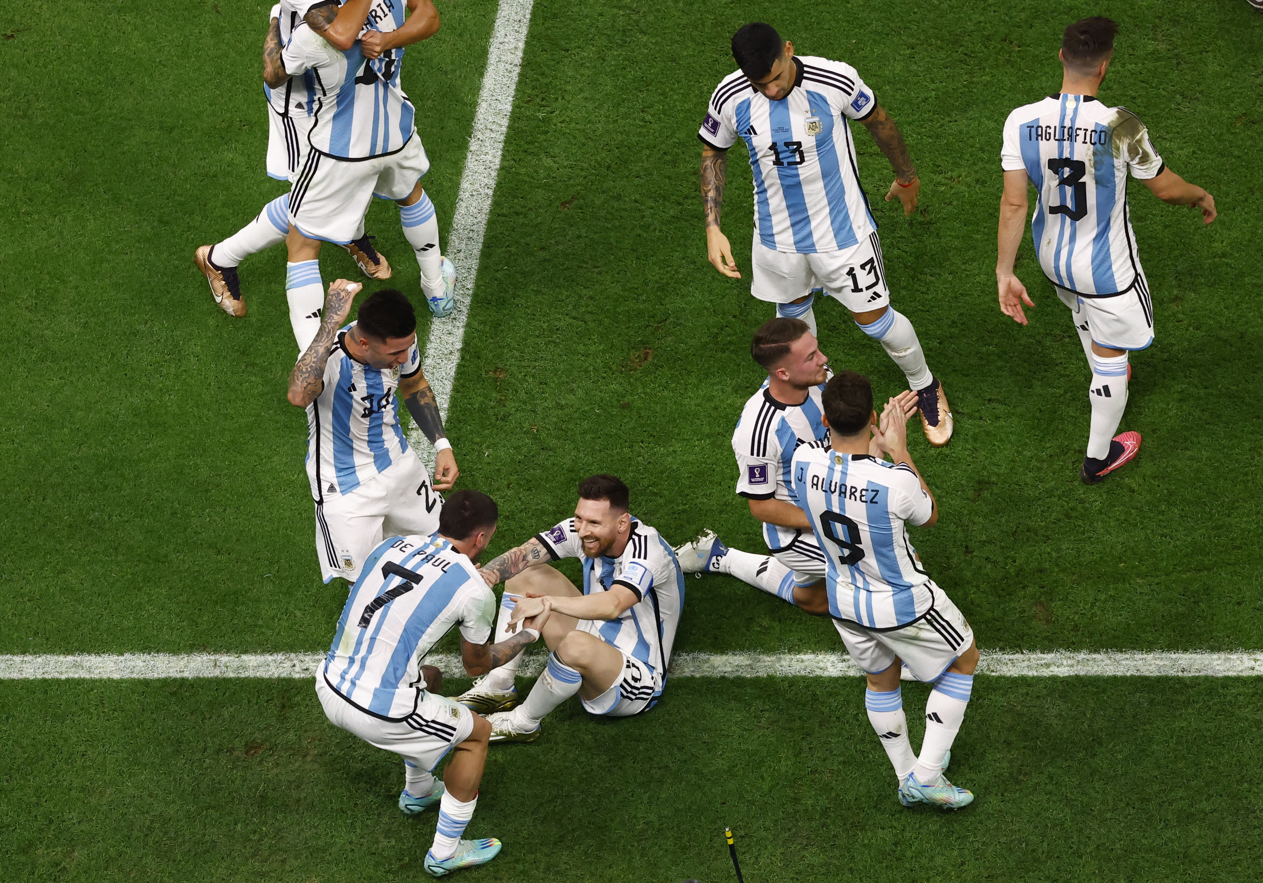 Soccer Football - FIFA World Cup Qatar 2022 - Final - Argentina v France - Lusail Stadium, Lusail, Qatar - December 18, 2022 Argentina's Lionel Messi celebrates scoring their first goal with teammates REUTERS/Peter Cziborra