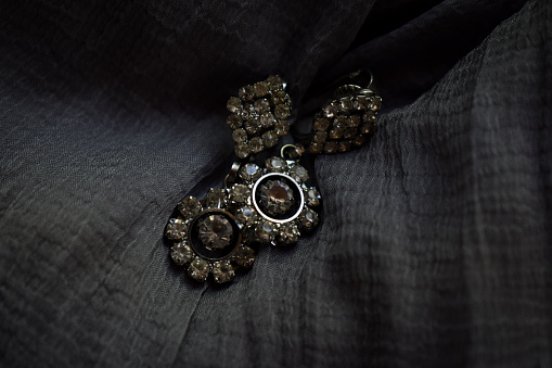Antique jewellery and antique wooden box in dark textured background
