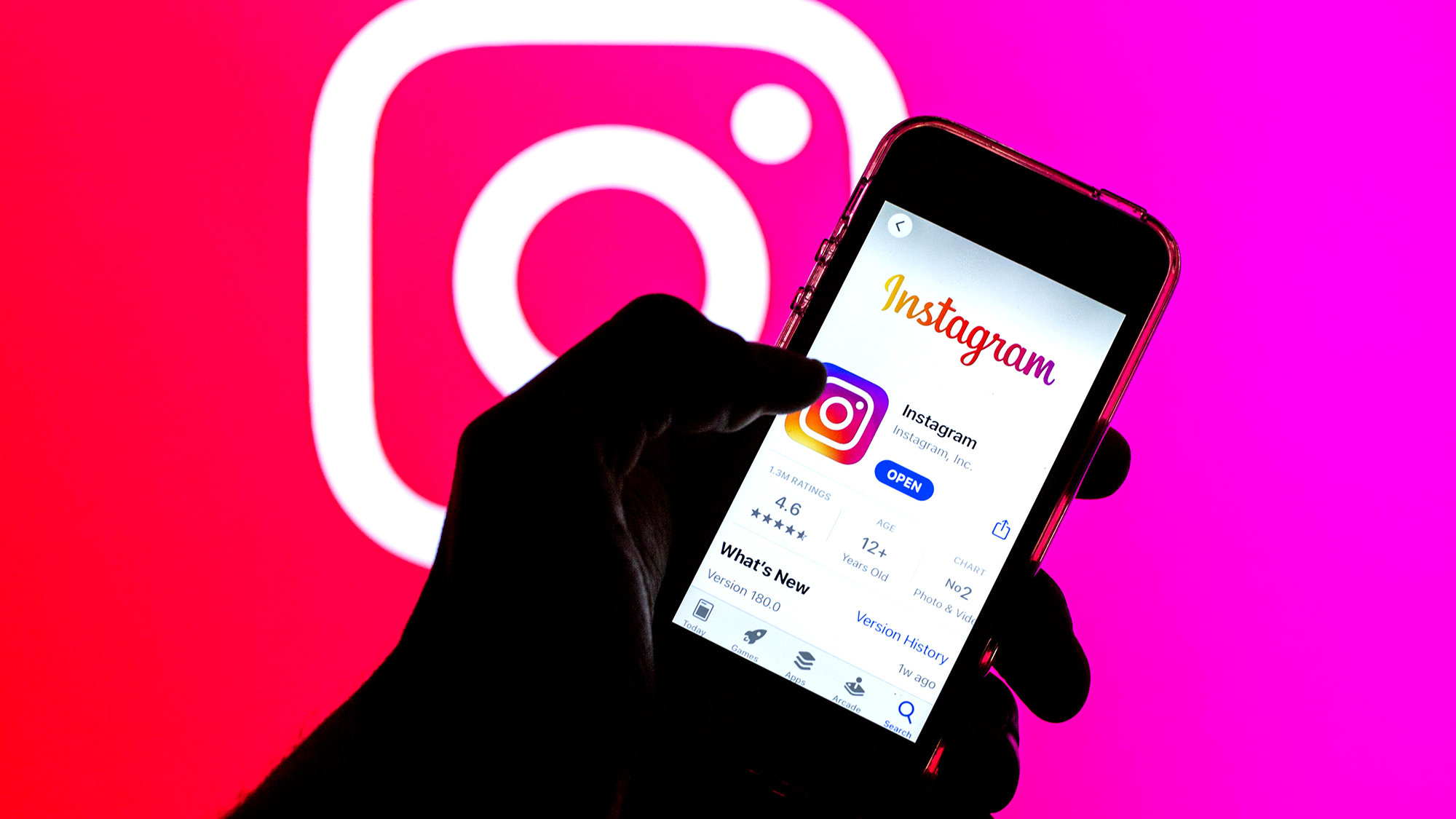 SPAIN - 2021/03/29: In this photo illustration, the Instagram app in App Store seen displayed on a smartphone screen and a Instagram logo in the background. (Photo Illustration by Thiago Prudencio/SOPA Images/LightRocket via Getty Images)