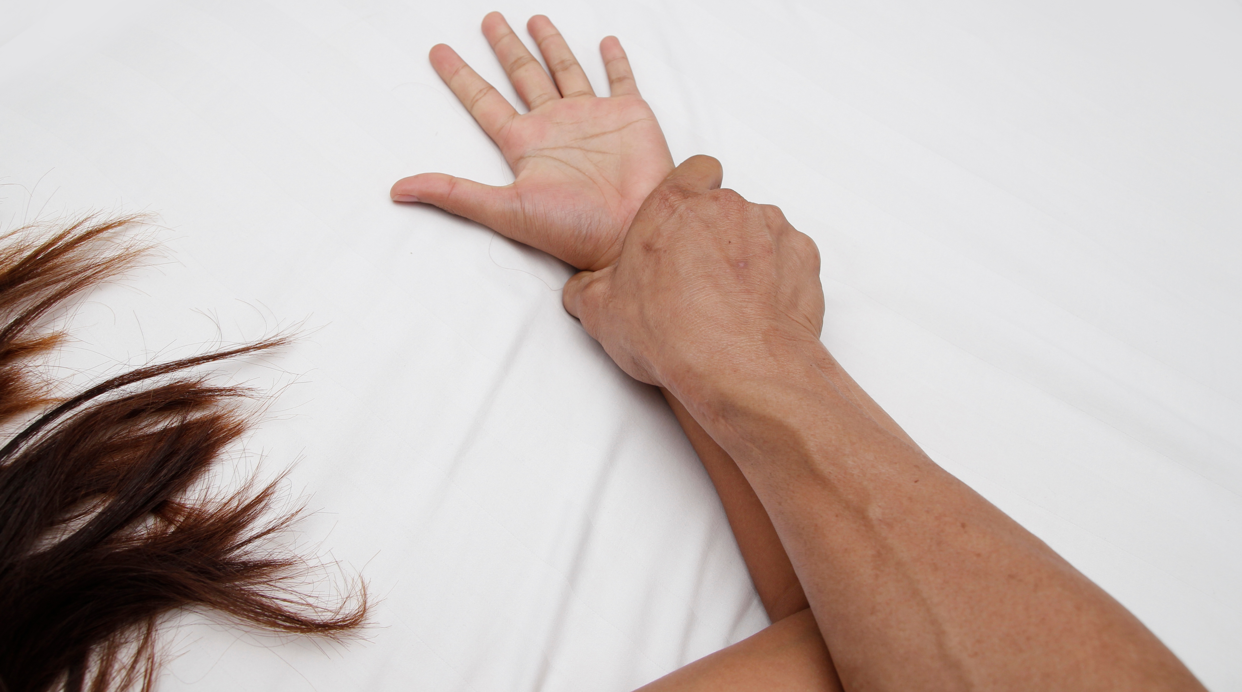 A hairy man's hand holding a woman hand for rape and sexual abuse concept                               