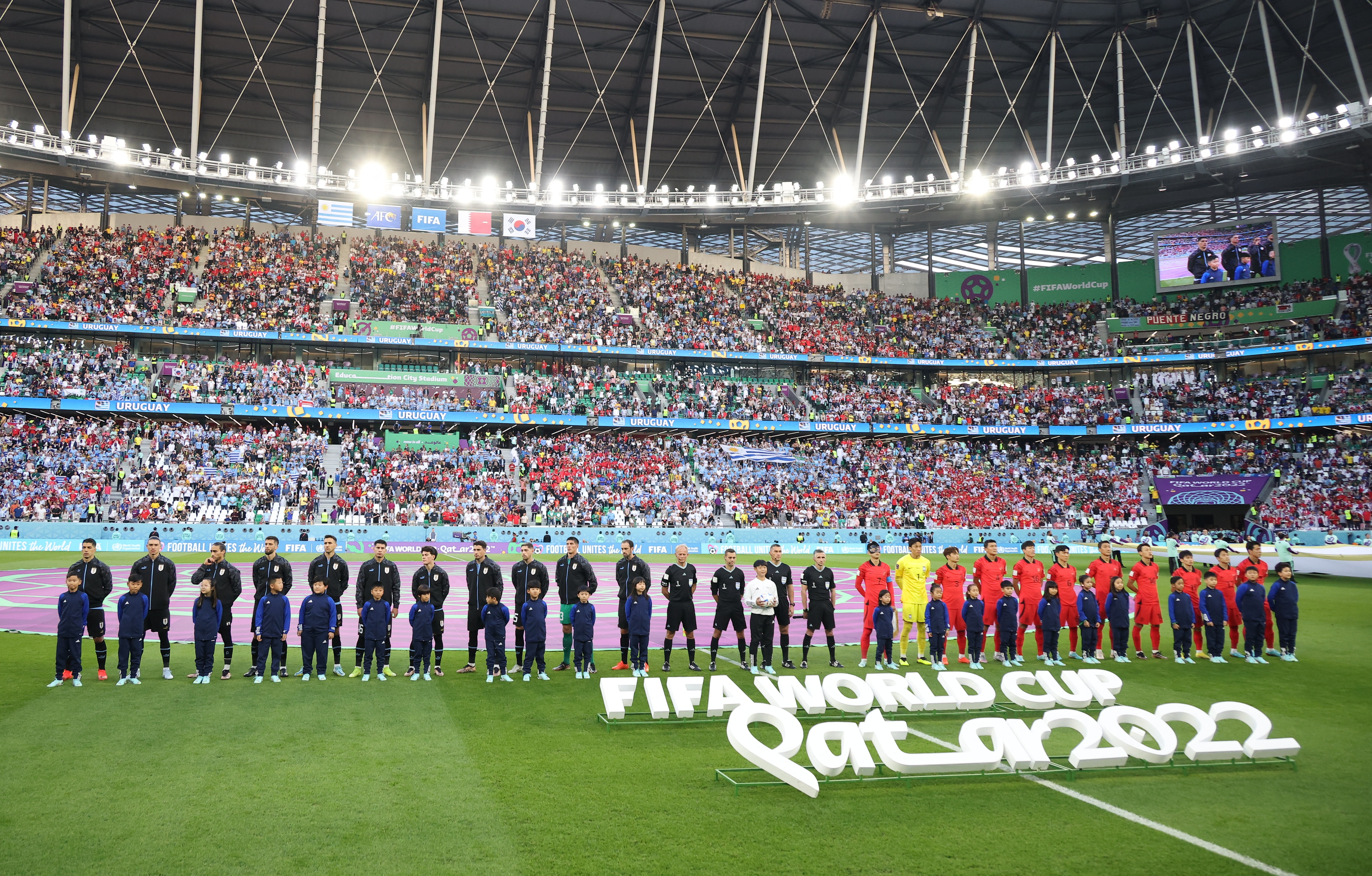 Soccer Football - FIFA World Cup Qatar 2022 - Group H - Uruguay v South Korea - Education City Stadium, Al Rayyan, Qatar - November 24, 2022  General view as the players line up during the national anthems before the match REUTERS/Kim Hong-Ji