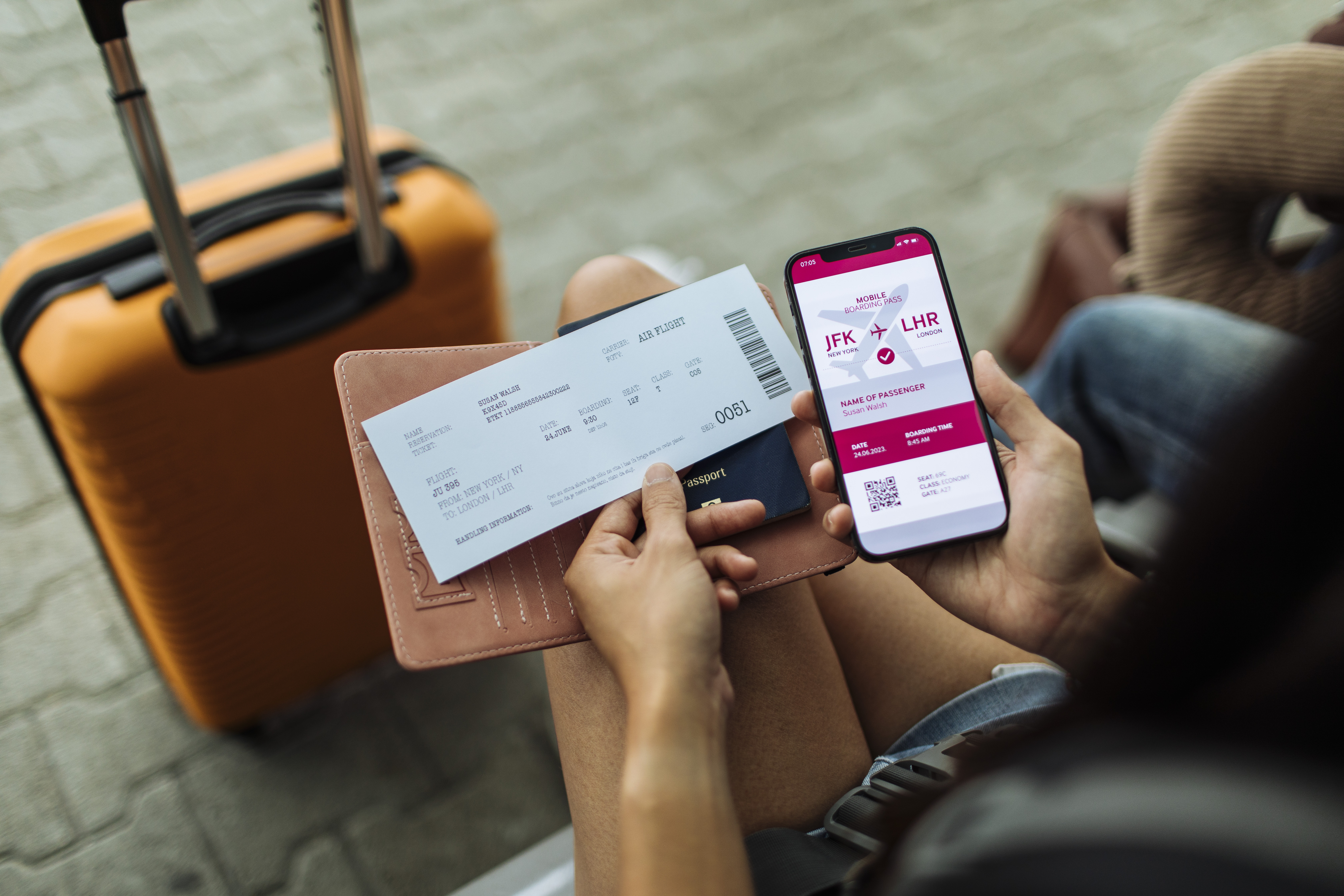 Close-up of the passport, phone, and ticket, with a bag in the distance