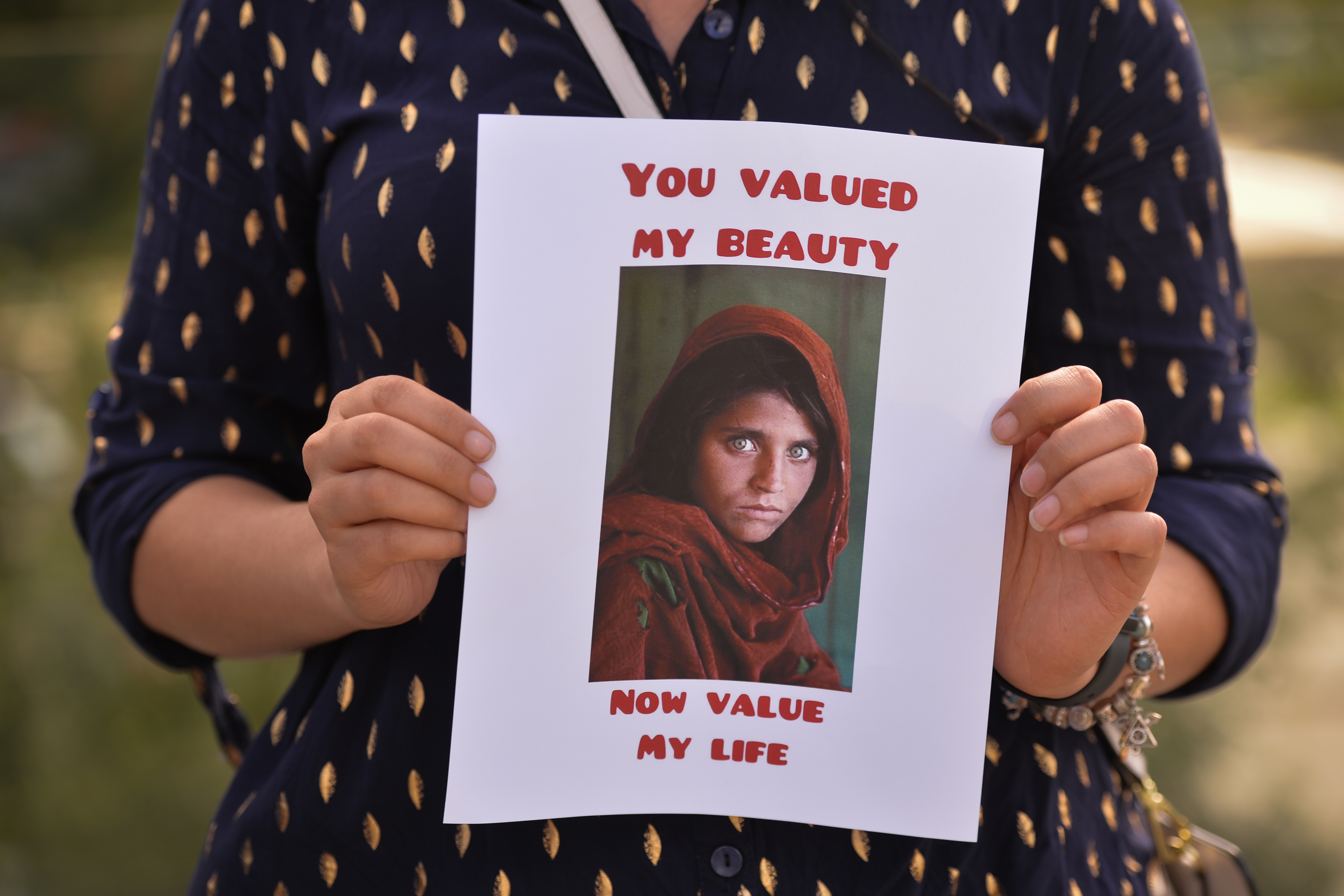 A protester holds the famous Afghan Girl photo - a 1984 photographic portrait of Sharbat Gula by photojournalist Steve McCurry with the words 'You Valued My Beauty, Now You Value My Life.'
Members of the local Afghan diaspora, activists and local supporters seen in front of the Alberta Legislature Building during the STOP KILLING AFGHANS! protest organised today by the Global Movement of Peace for Afghanistan.
Saturday, August 28, 2021, in Edmonton, Alberta, Canada. (Photo by Artur Widak/NurPhoto via Getty Images)