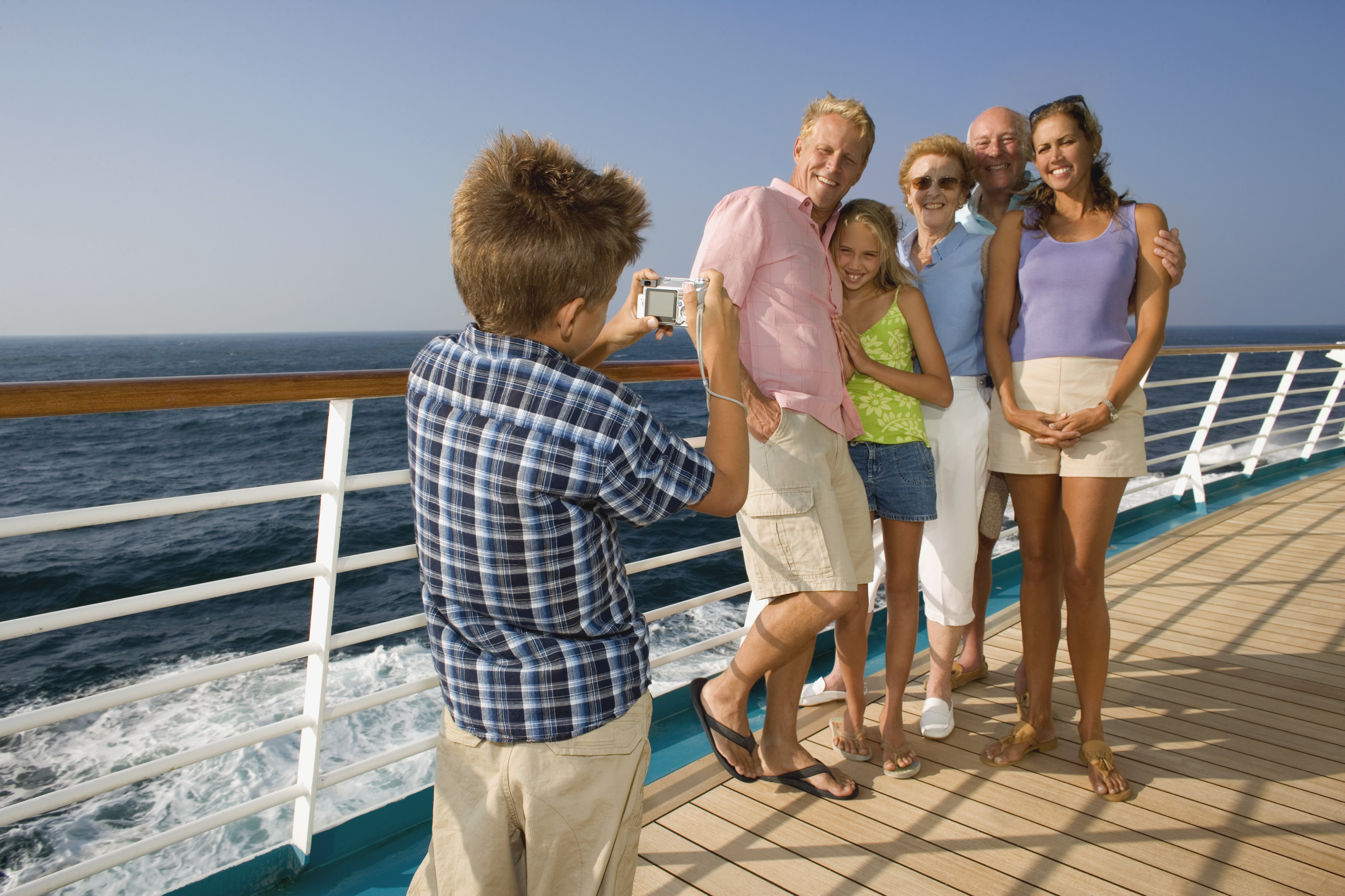 Parents with children (10-12) on cruise ship looking at ocean