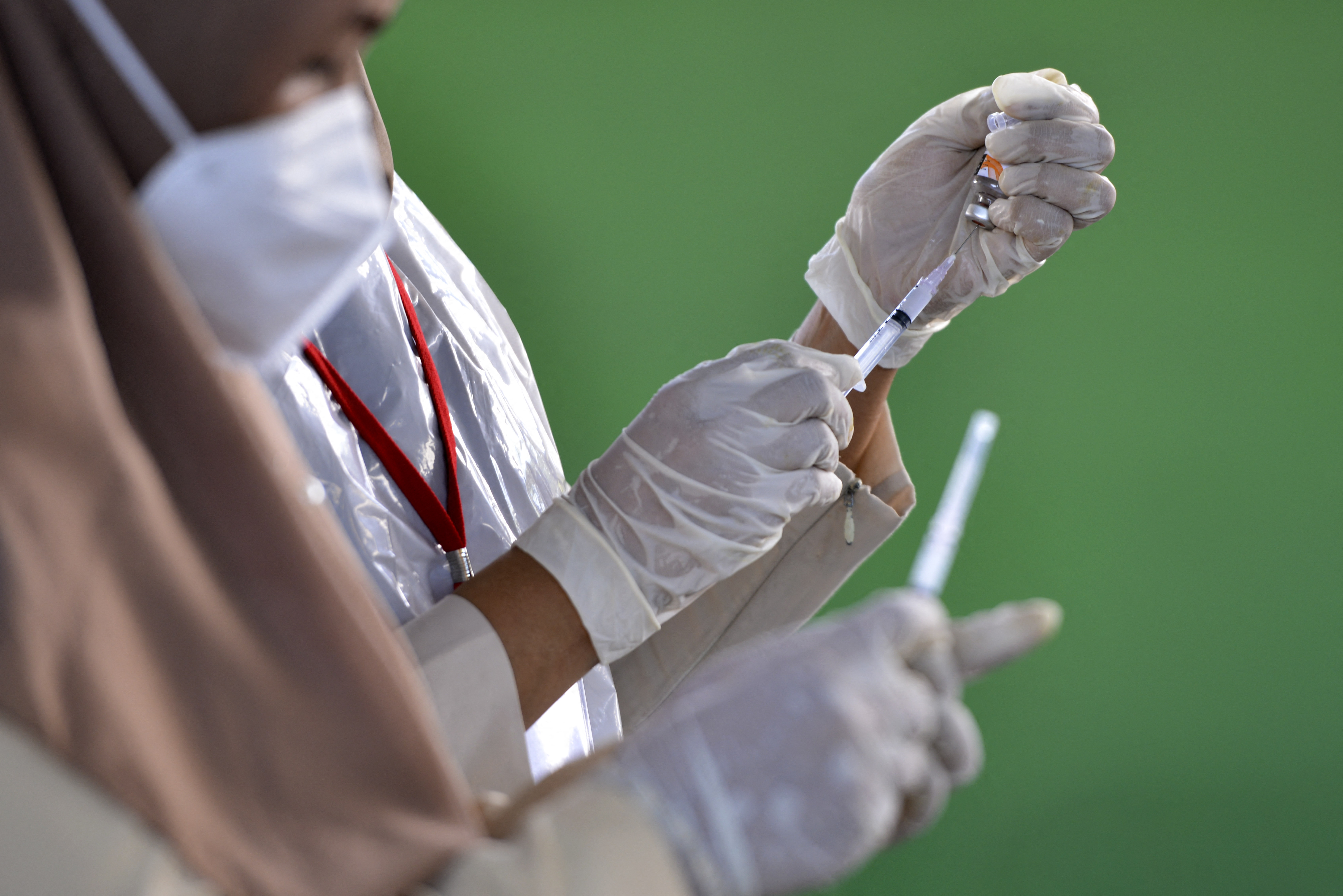 Health workers prepare to administer the Sinovac Covid-19 coronavirus vaccine in Banda Aceh on April 20, 2021. (Photo by CHAIDEER MAHYUDDIN / AFP)