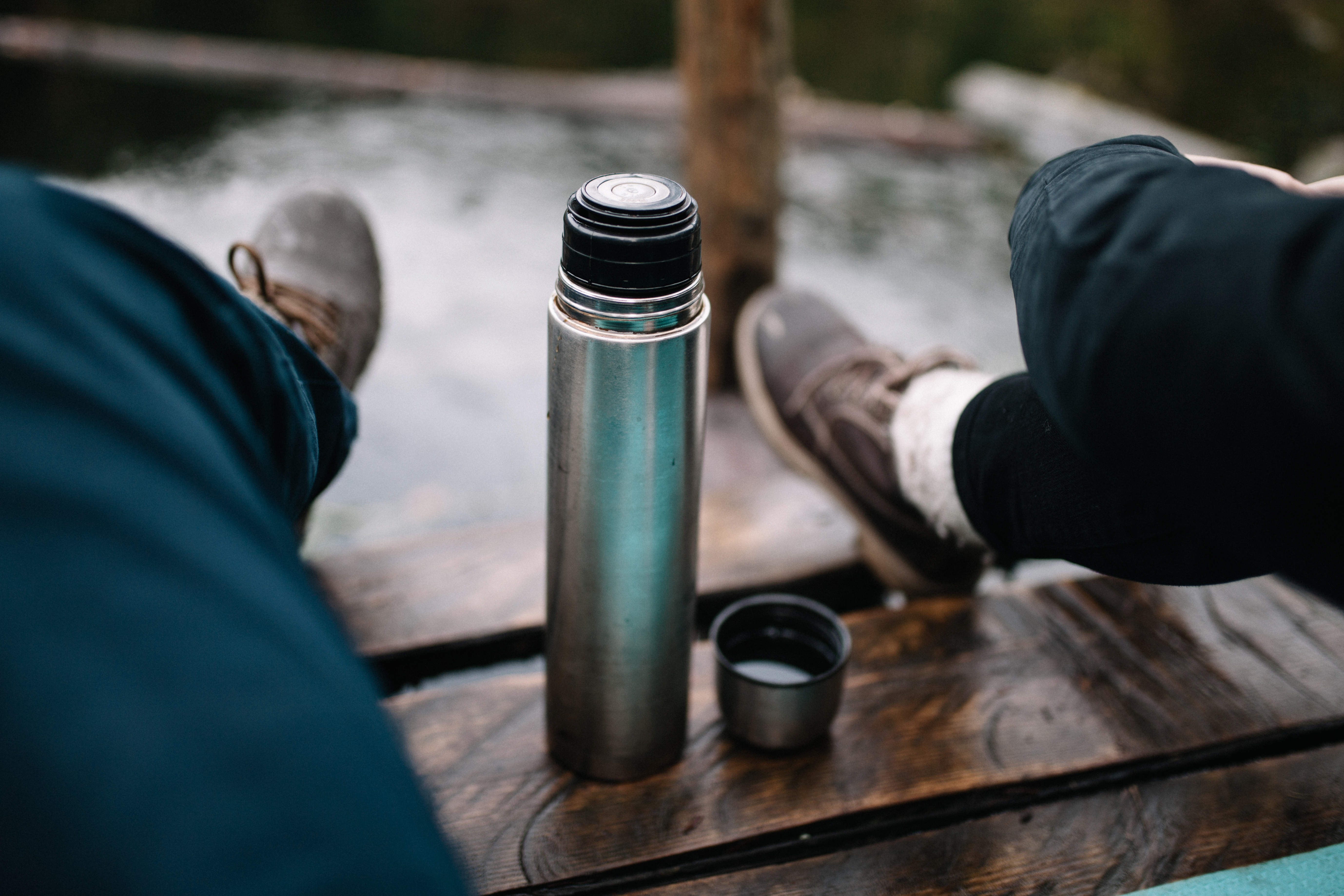 Young Caucasian couple drinking tea from thermos