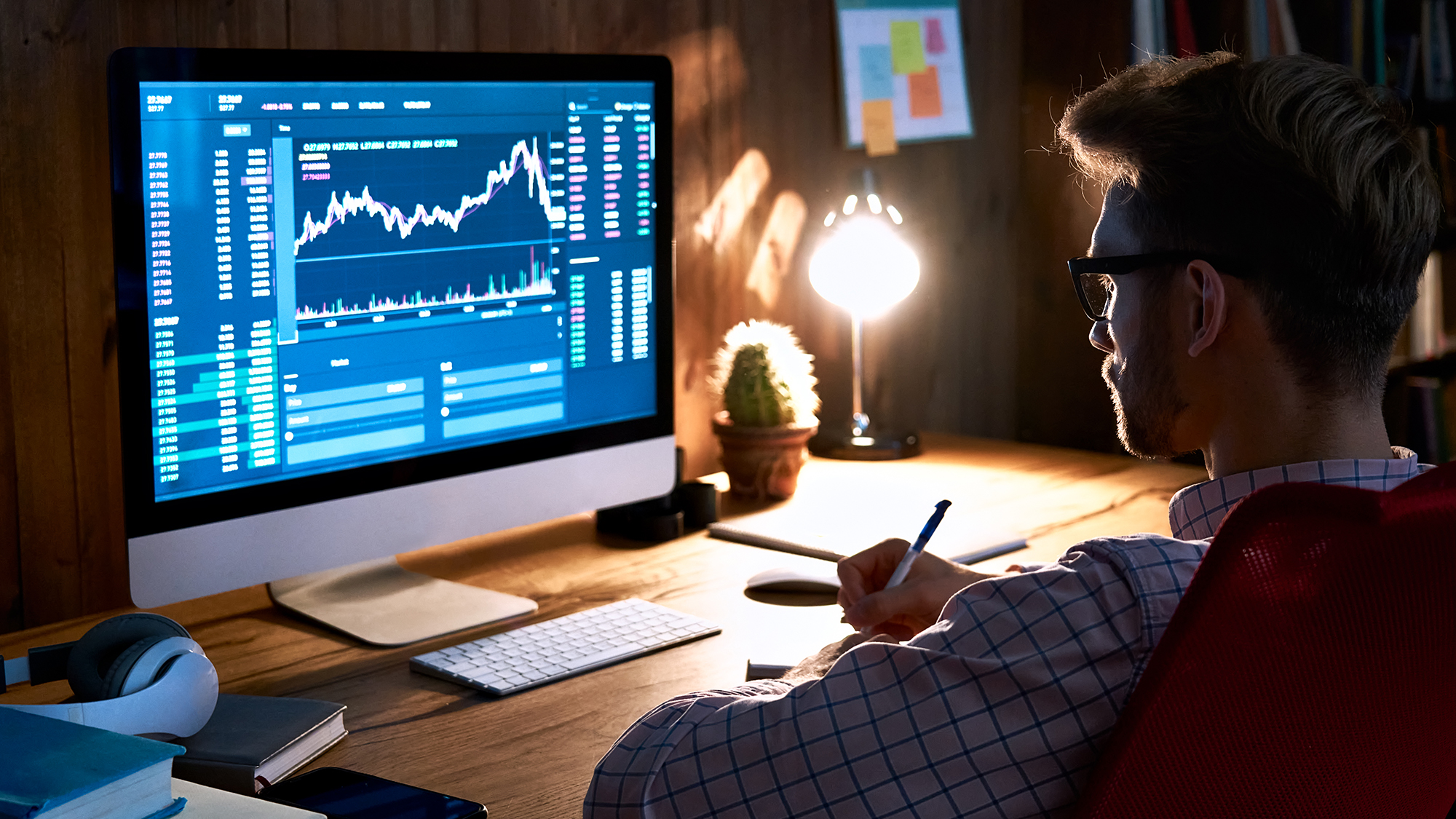 Corredor de bolsa de valores de hombre de negocios que mira la pantalla de la computadora de la PC, gerente de inversionistas que analiza el gráfico financiero que negocia el gráfico del mercado de divisas criptográficas del precio de los datos de inversión en línea, gestionando los riesgos.