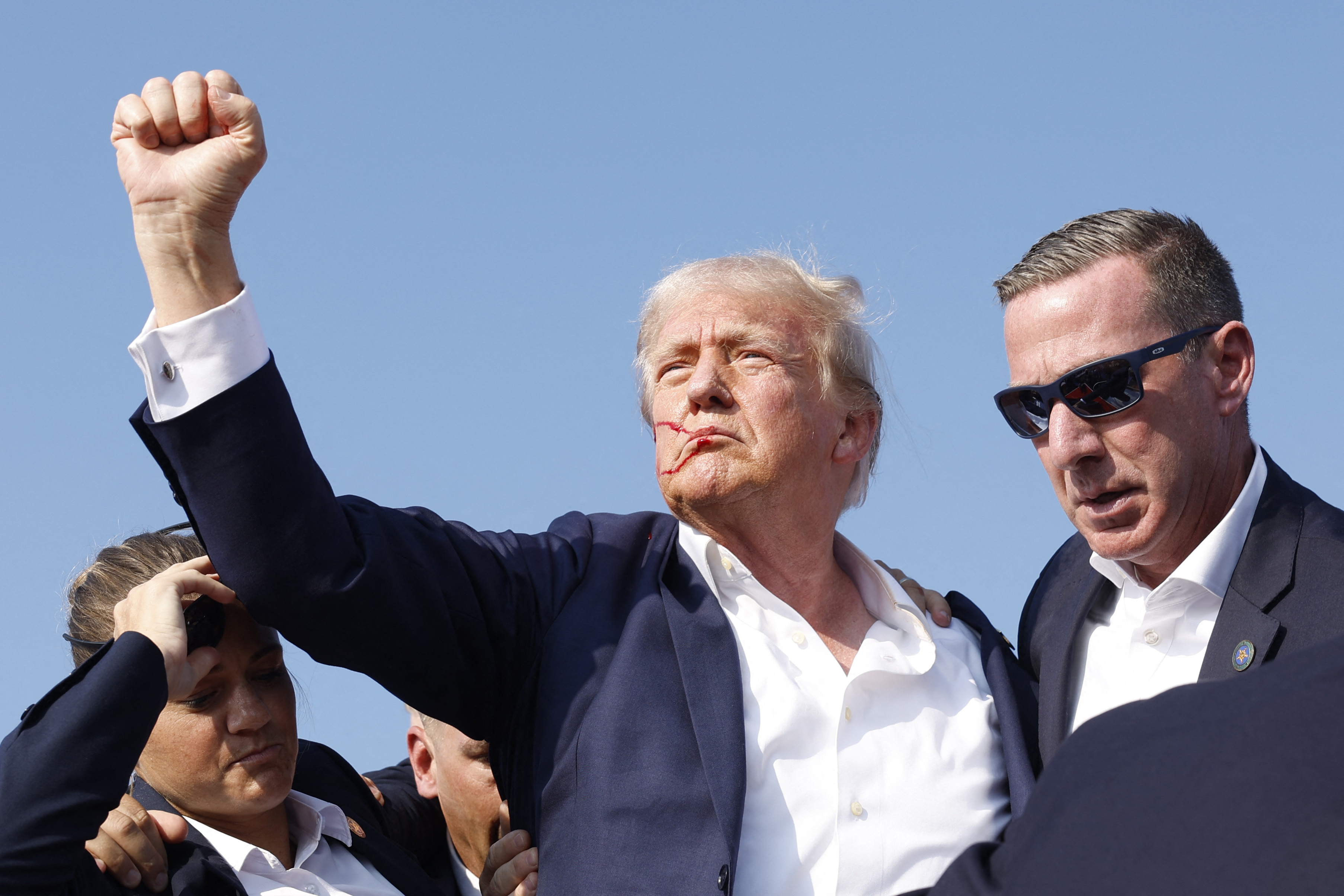 BUTLER, PENNSYLVANIA - JULY 13: Republican presidential candidate former President Donald Trump is rushed offstage during a rally on July 13, 2024 in Butler, Pennsylvania.   Anna Moneymaker/Getty Images/AFP (Photo by Anna Moneymaker / GETTY IMAGES NORTH AMERICA / Getty Images via AFP)
