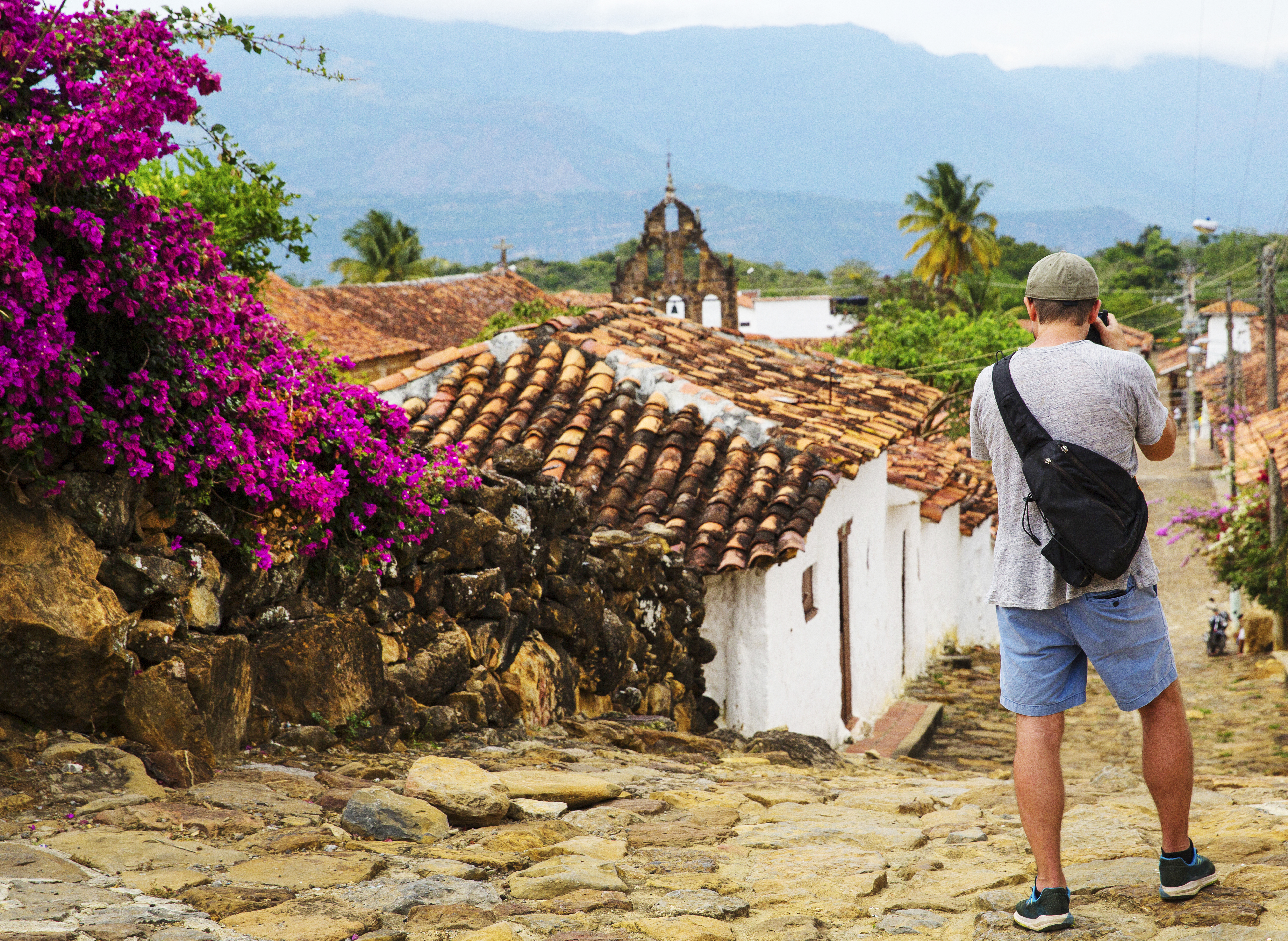 A traveller stopping to take a photograph the beautiful village of Guane, that is reached by taking the historic "Camino Real", a stone path about a two hour walk from the town of Barichara. The road, built by the indigenous Guane,has been declared a national monument.