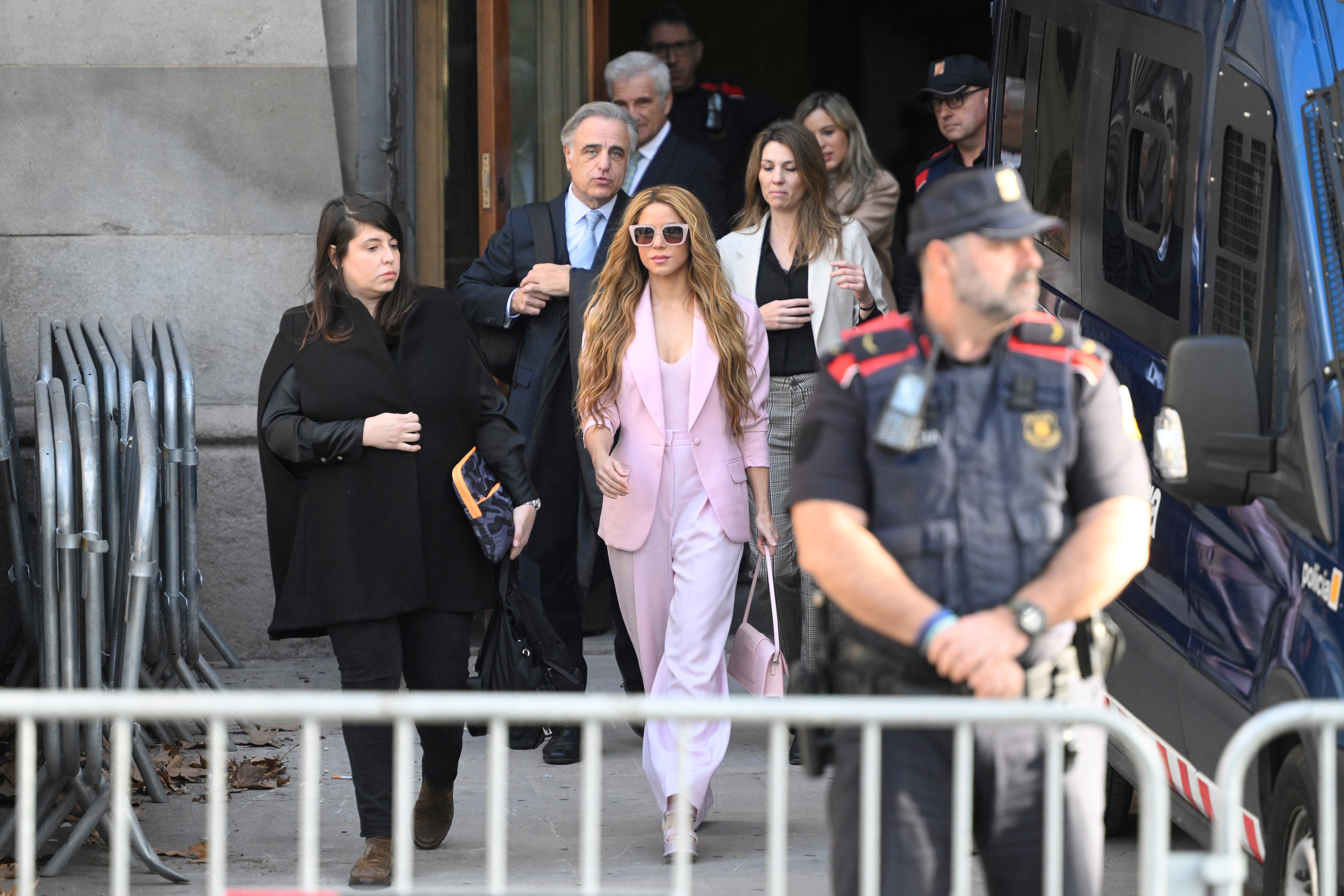 Colombian singer Shakira (C) leaves the High Court of Justice of Catalonia after attending her trial on tax fraud, in Barcelona on November 20, 2023. Colombian superstar Shakira has reached a deal with prosecutors to end her trial for allegedly defrauding the Spanish state of 14.5 million euros ($15.7 million) on income earned between 2012 and 2014, a Barcelona court said. Under the deal, the 46-year-old agreed to receive a three-year suspended sentence in exchange for paying millions of euros in fines, the head of the court said on what would have been the first day of her trial. (Photo by Josep LAGO / AFP)