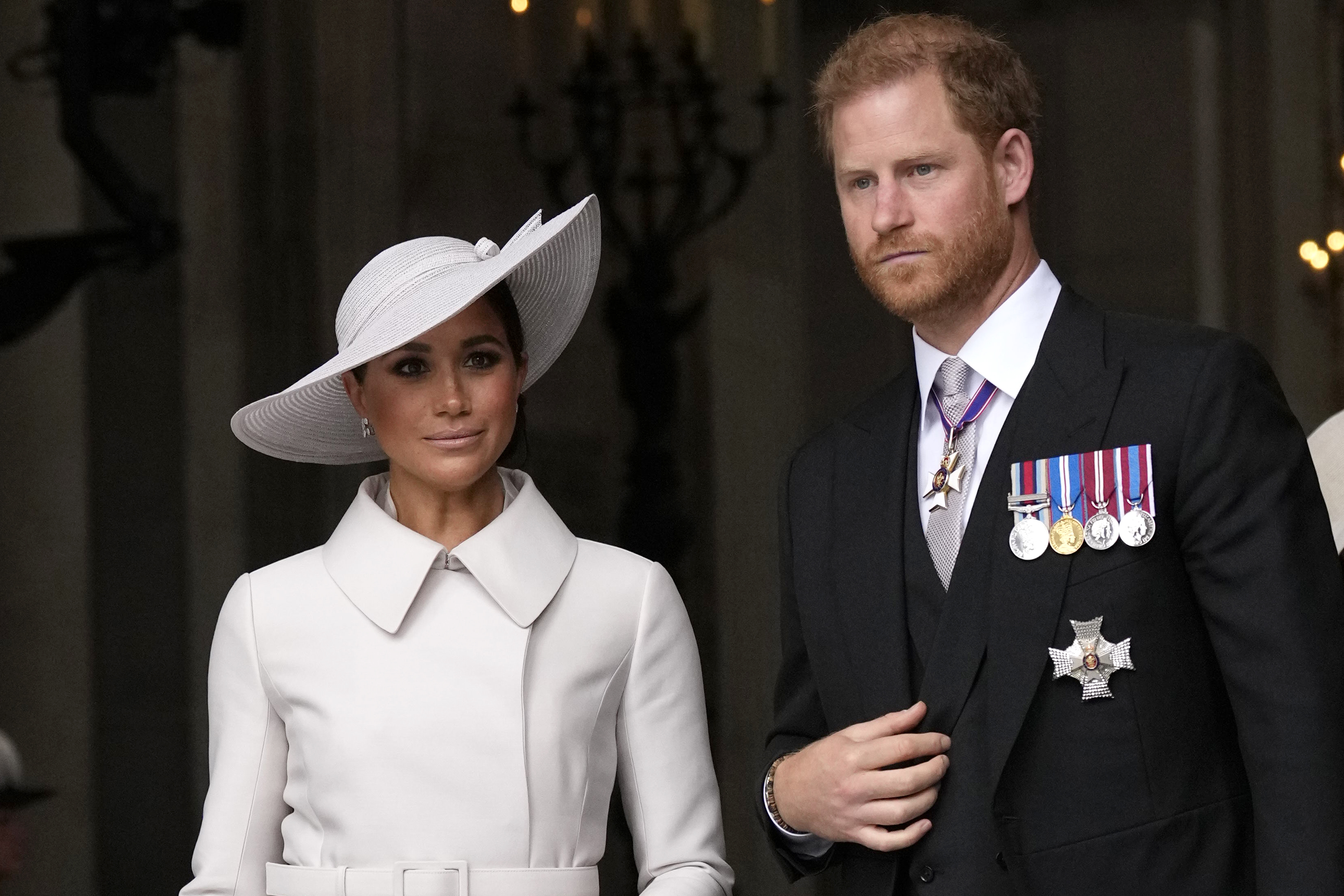 FILE - Prince Harry and Meghan Markle, Duke and Duchess of Sussex leave after a service of thanksgiving for the reign of Queen Elizabeth II at St Paul's Cathedral in London, Friday, June 3, 2022. The Duke of Sussex is scheduled to testify in the High Court after his lawyer presents opening statements Monday, June 5, 2023 in his case alleging phone hacking. It’s the first of Harry’s several legal cases against the media to go to trial and one of three alleging tabloid publishers unlawfully snooped on him.  (AP Photo/Matt Dunham, Pool, File)