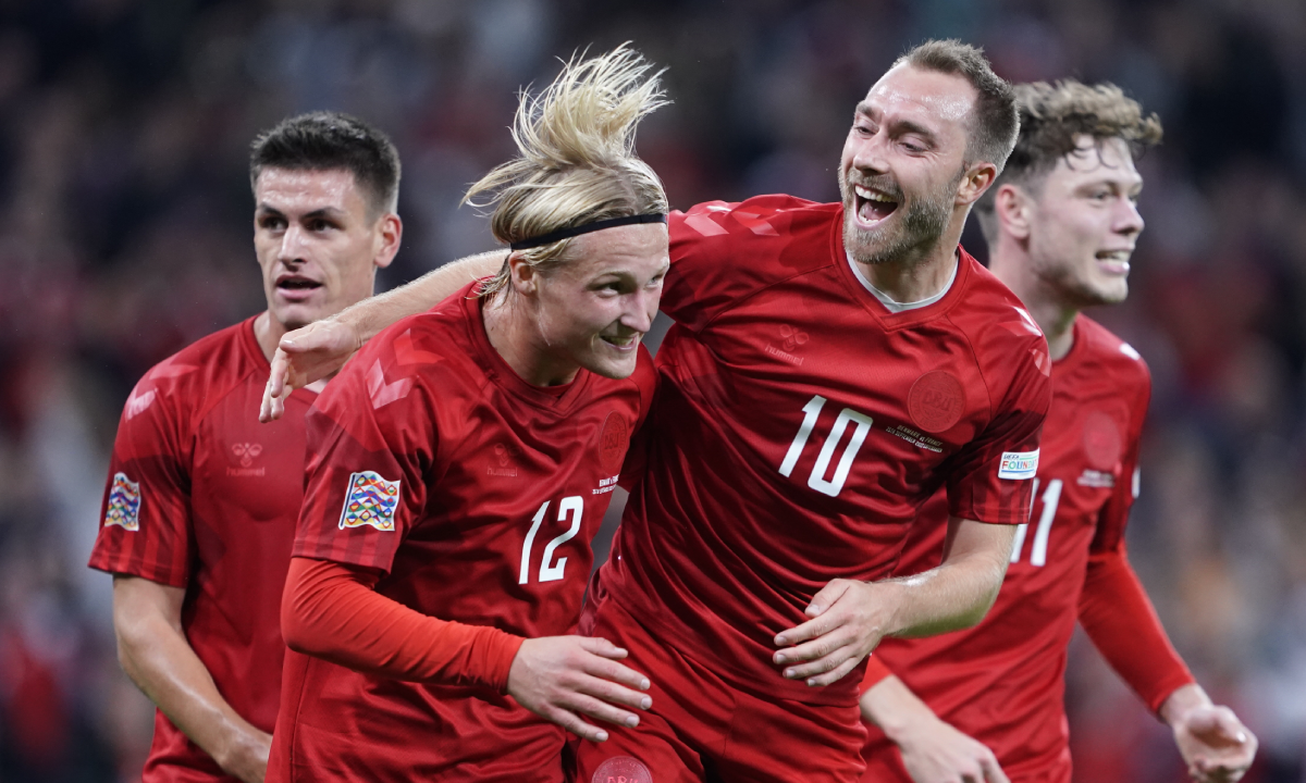 Denmark's Kasper Dolberg, second left, celebrates scoring with teammates Christian Eriksen, center right, Joachim Maehle and Andreas Skov Olsen, right, during the UEFA Nations League soccer match between Denmark and France at Parken Stadium in Copenhagen, Denmark, Sunday Sept. 25, 2022. (Liselotte Sabroe/Ritzau Scanpix via AP)