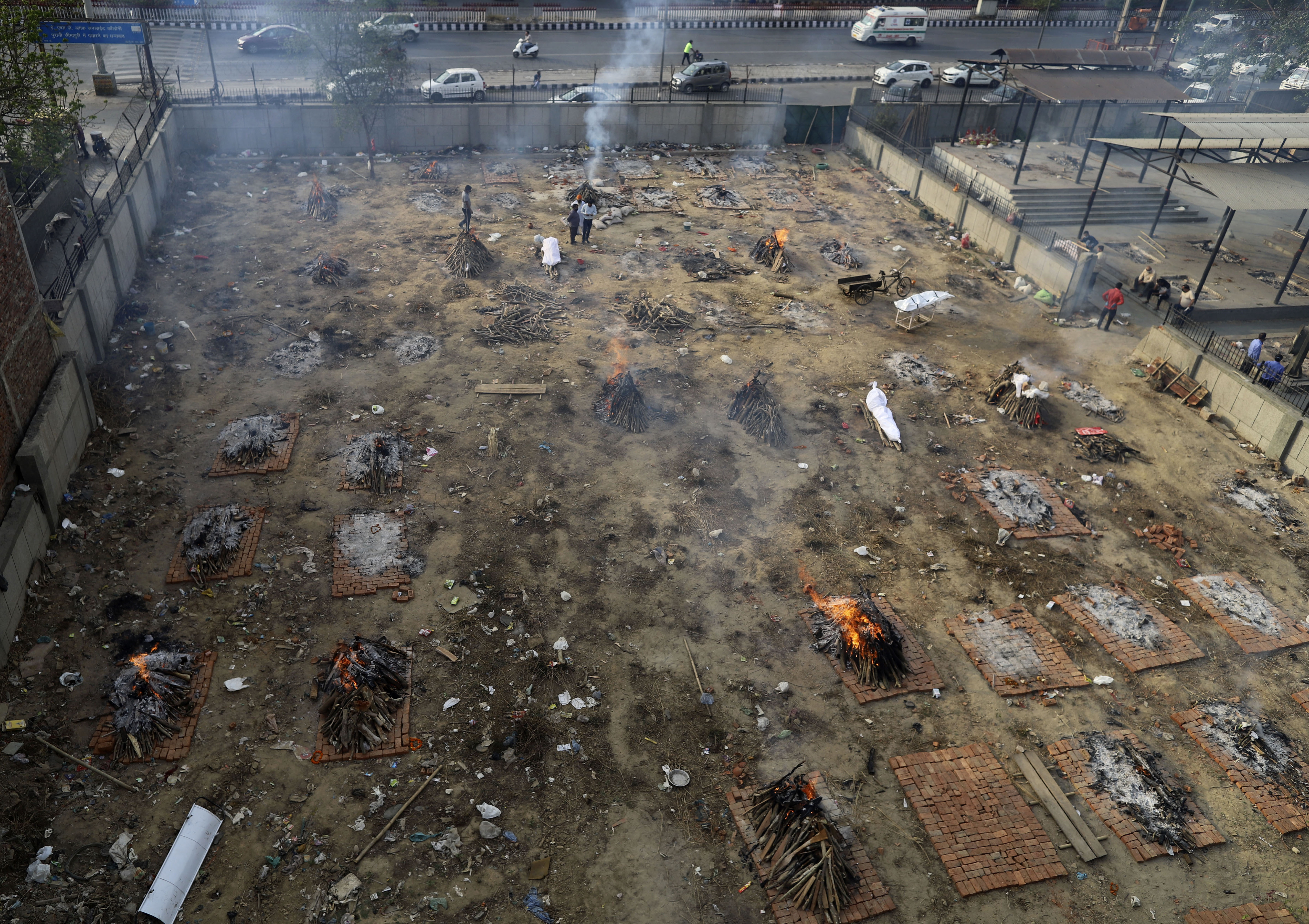Multiple funeral pyres of victims of COVID-19 burn in a ground that has been converted into a crematorium for mass cremation, in New Delhi, India, Wednesday, April 21, 2021. India’s underfunded health system is tattering as the world’s worst coronavirus surge wears out the nation, which set a global record in daily infections for a second straight day with 332,730. (AP Photo)
